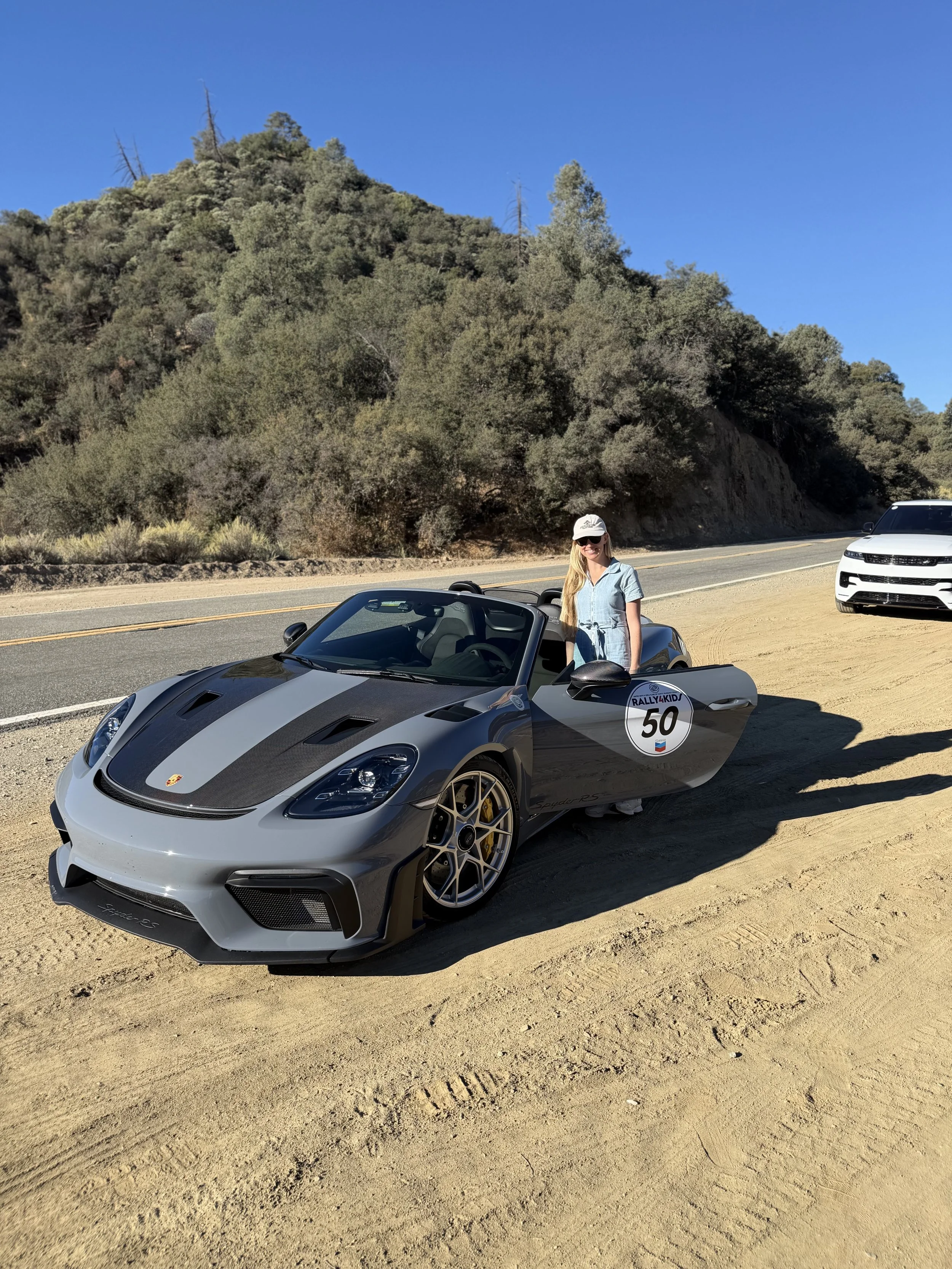 woman-beside-gray-porsche-convertible-at-rocky-roadside--0f7bfca7.jpeg