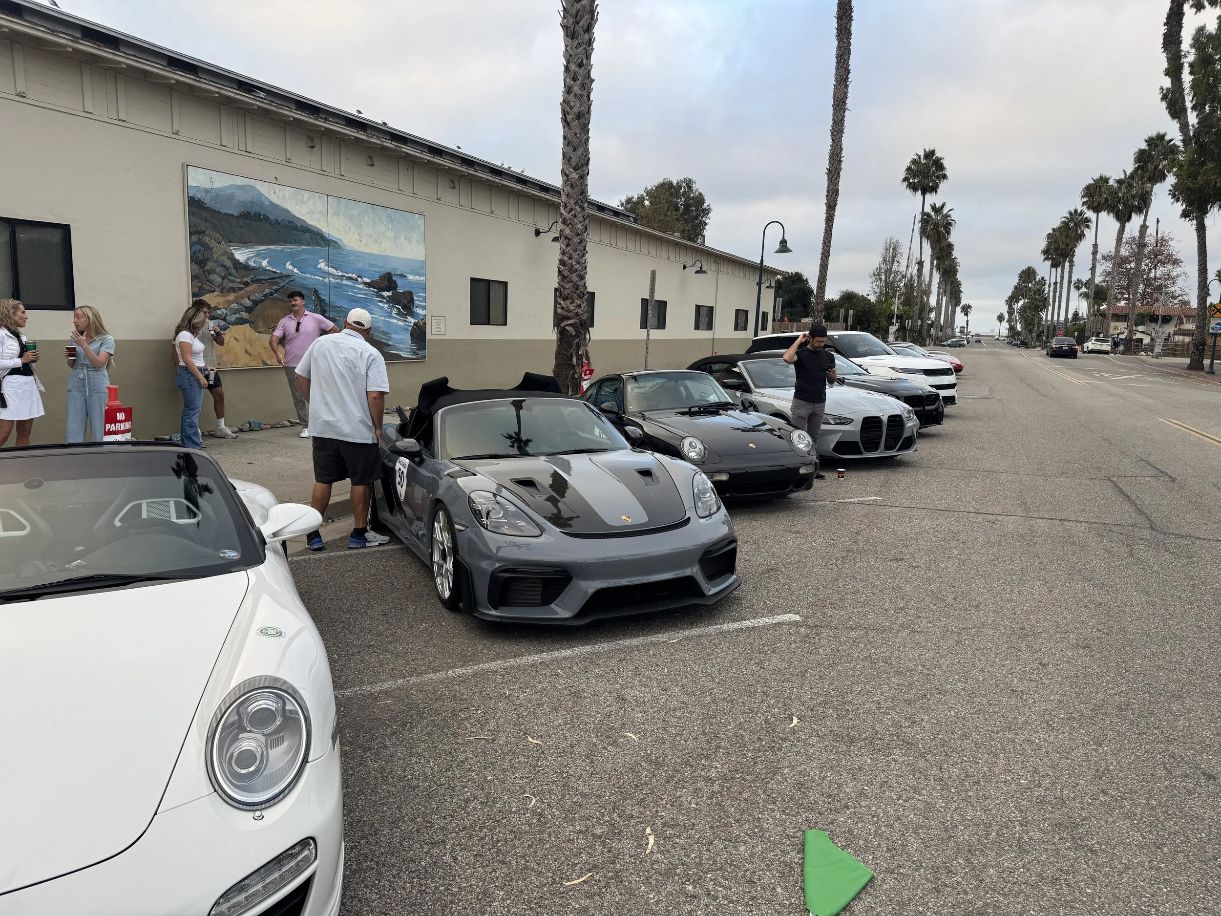 gray-convertible-sports-car-parked-on-street-with-people-nearby--e6ddada8.jpeg