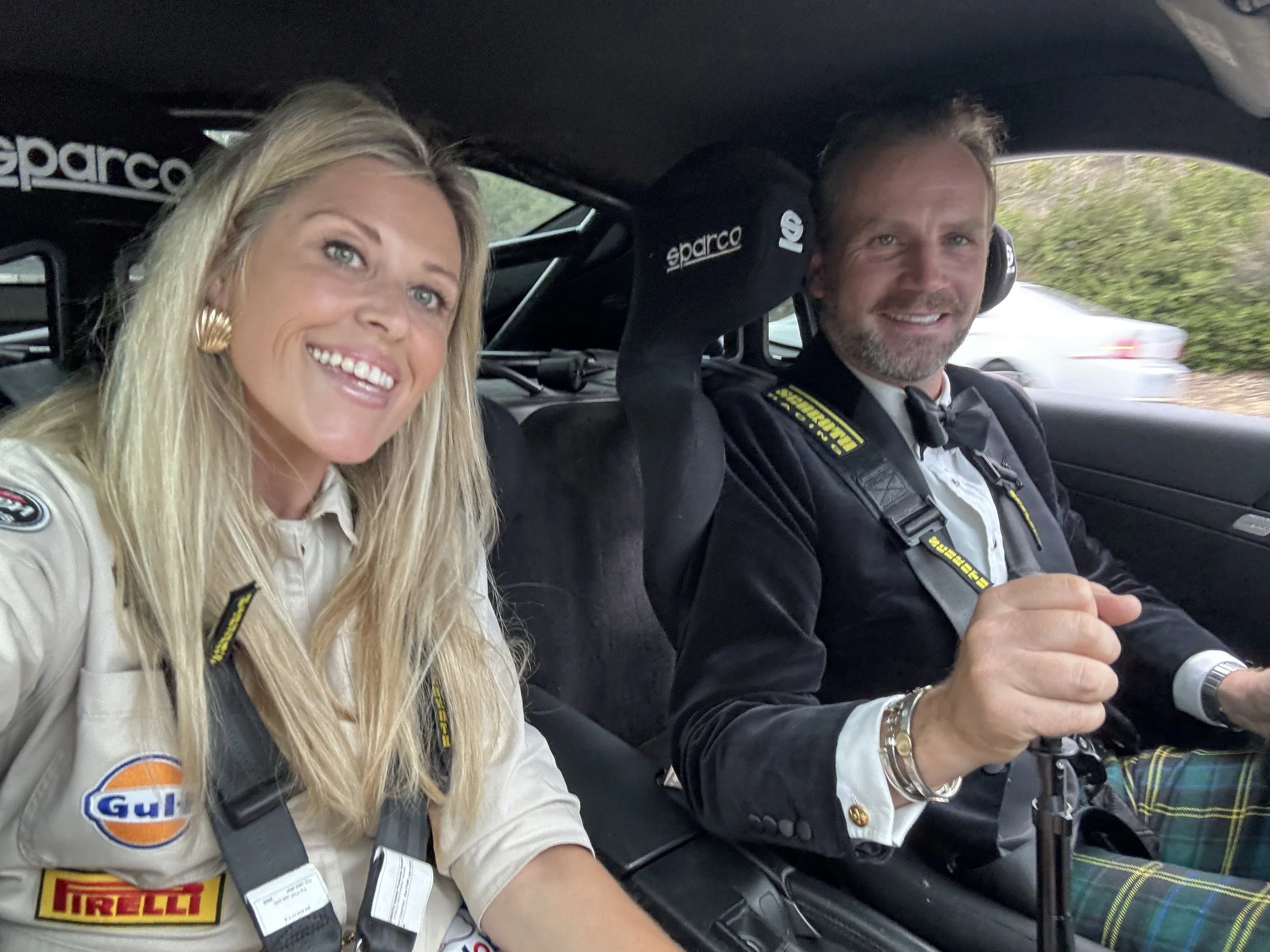 smiling-blonde-woman-in-racing-suit-and-man-in-tuxedo--b3f2efbf.jpeg