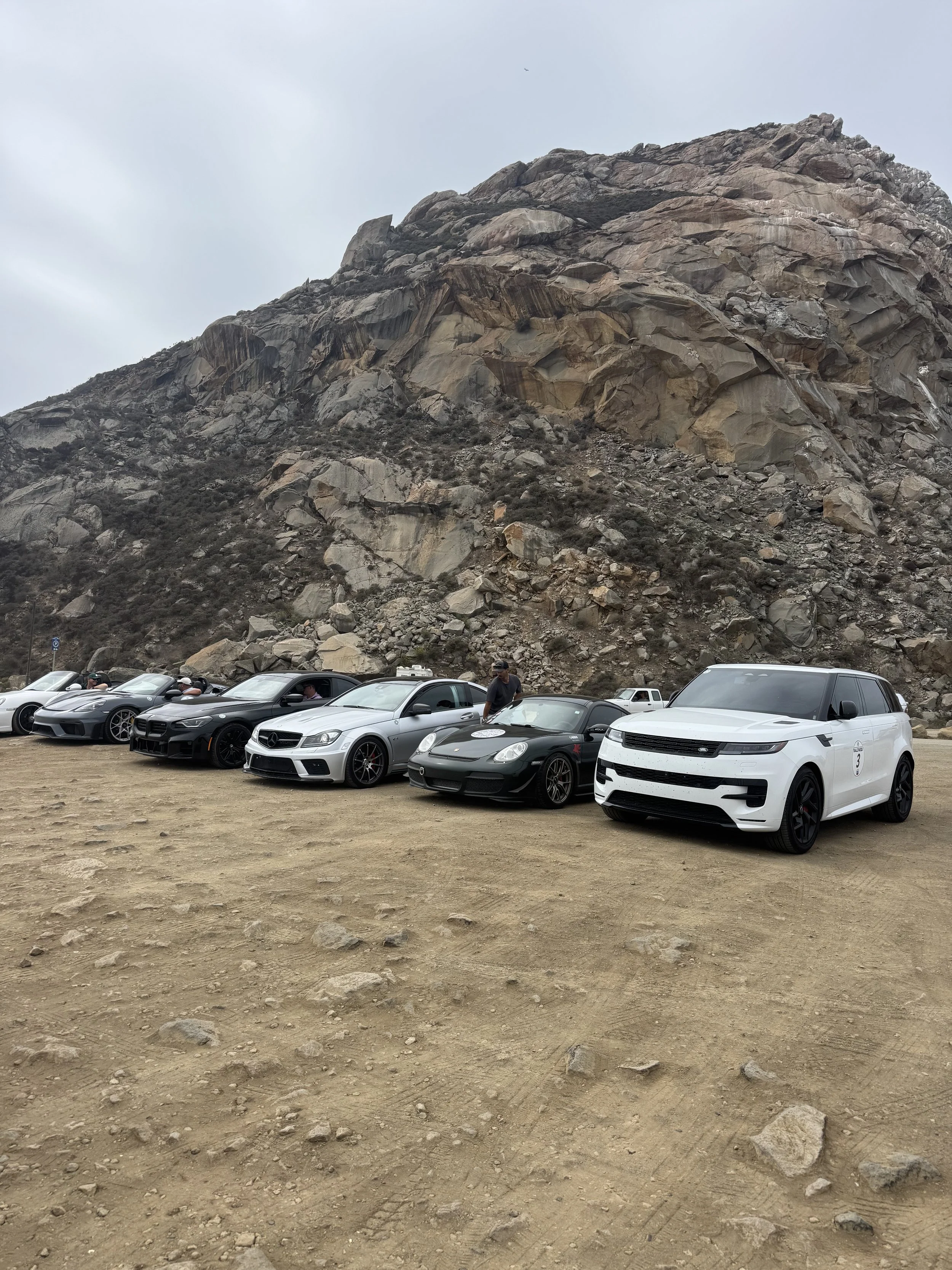 white-suv-with-number-7-parked-with-sports-cars-near-rocky-mountain--ab4b3934.jpeg