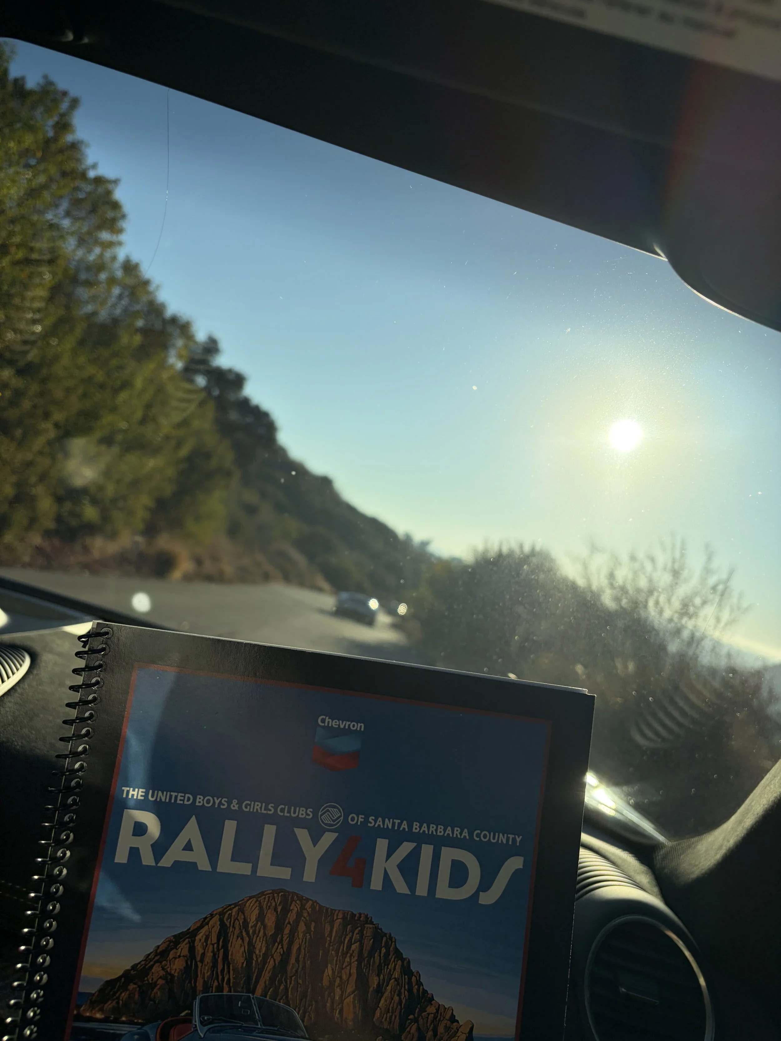 rally-kids-route-book-beneath-sunlit-windshield--797d8664.jpeg