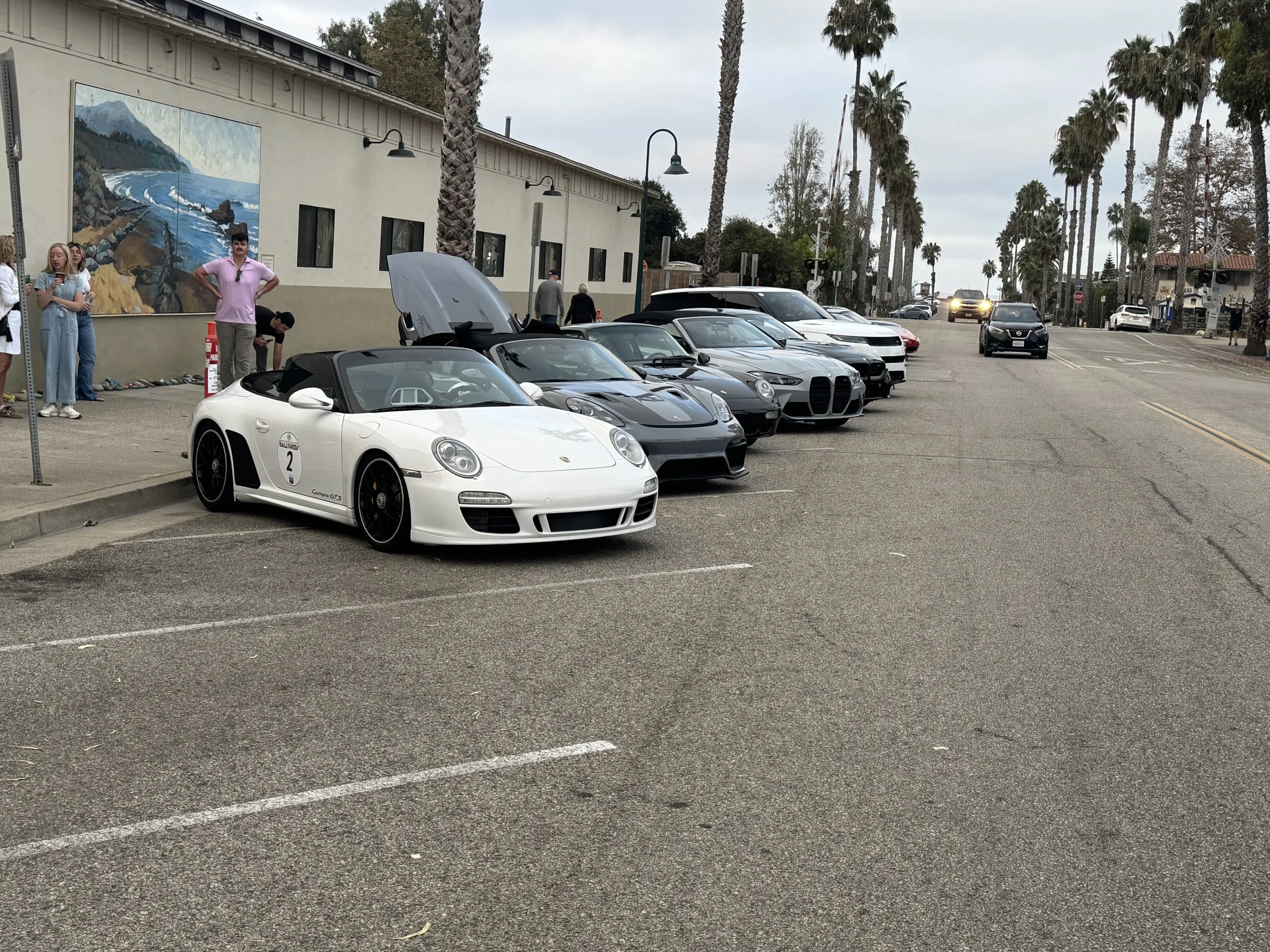 white-convertible-sports-car-with-number-2-parked-on-street--9e6845bc.jpeg