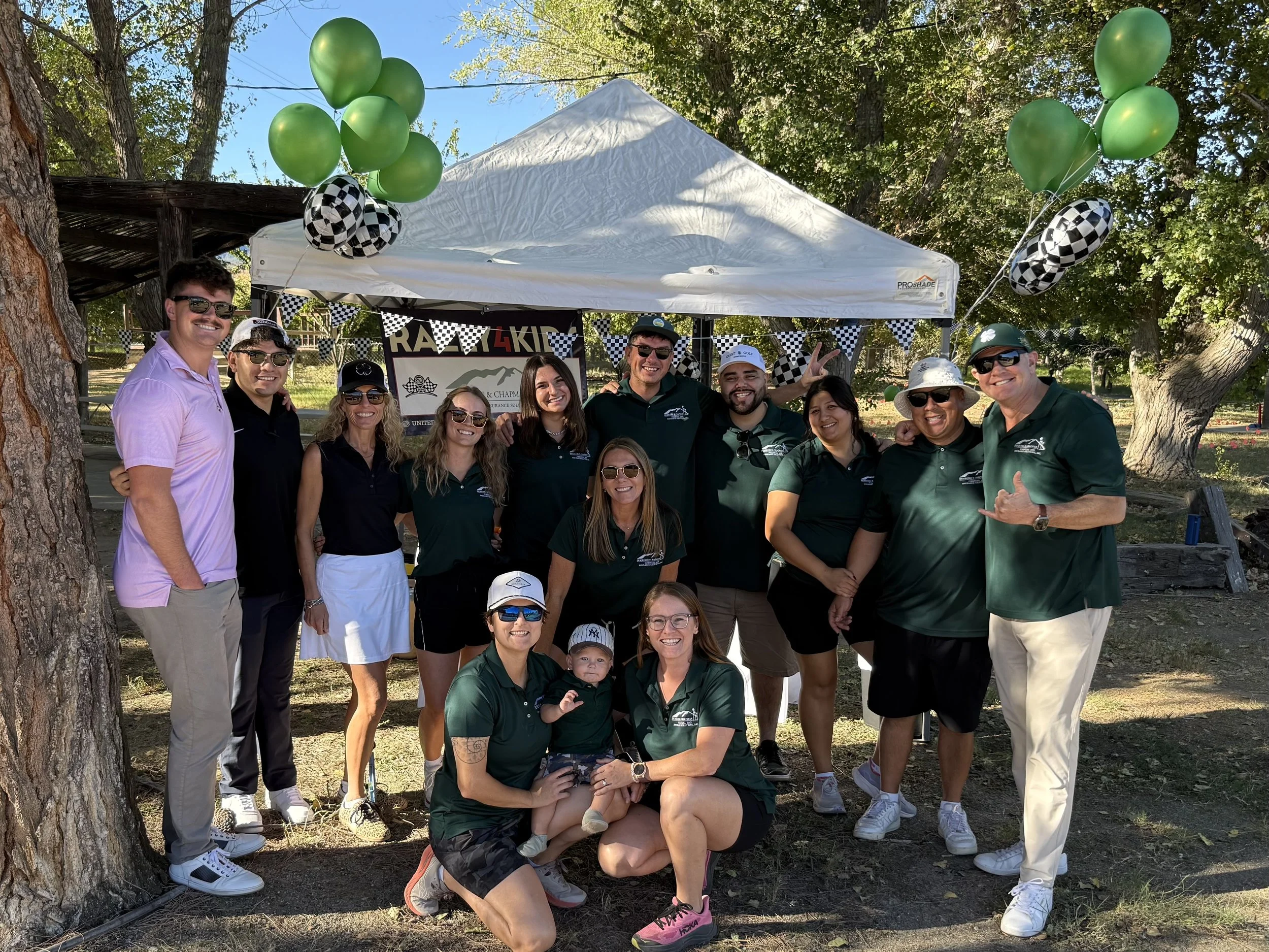 group-of-people-in-green-shirts-under-white-tent-with-green-balloons--ca1b9edc.jpeg