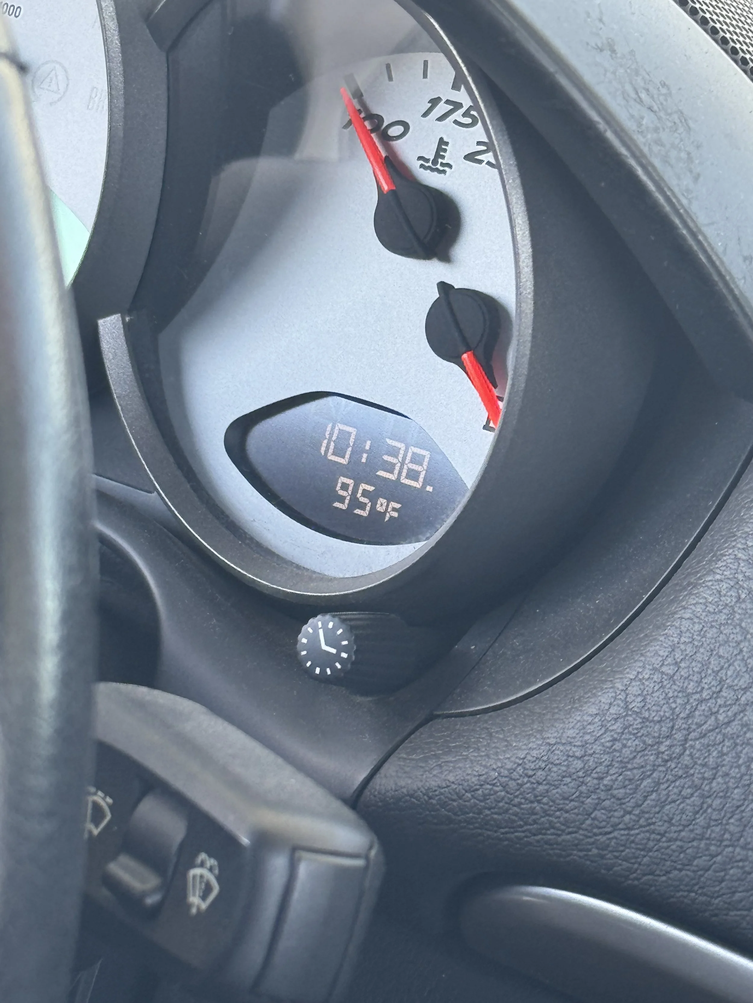 car-dashboard-showing-temperature-gauge-and-digital-clock--9e7bf2ff.jpeg