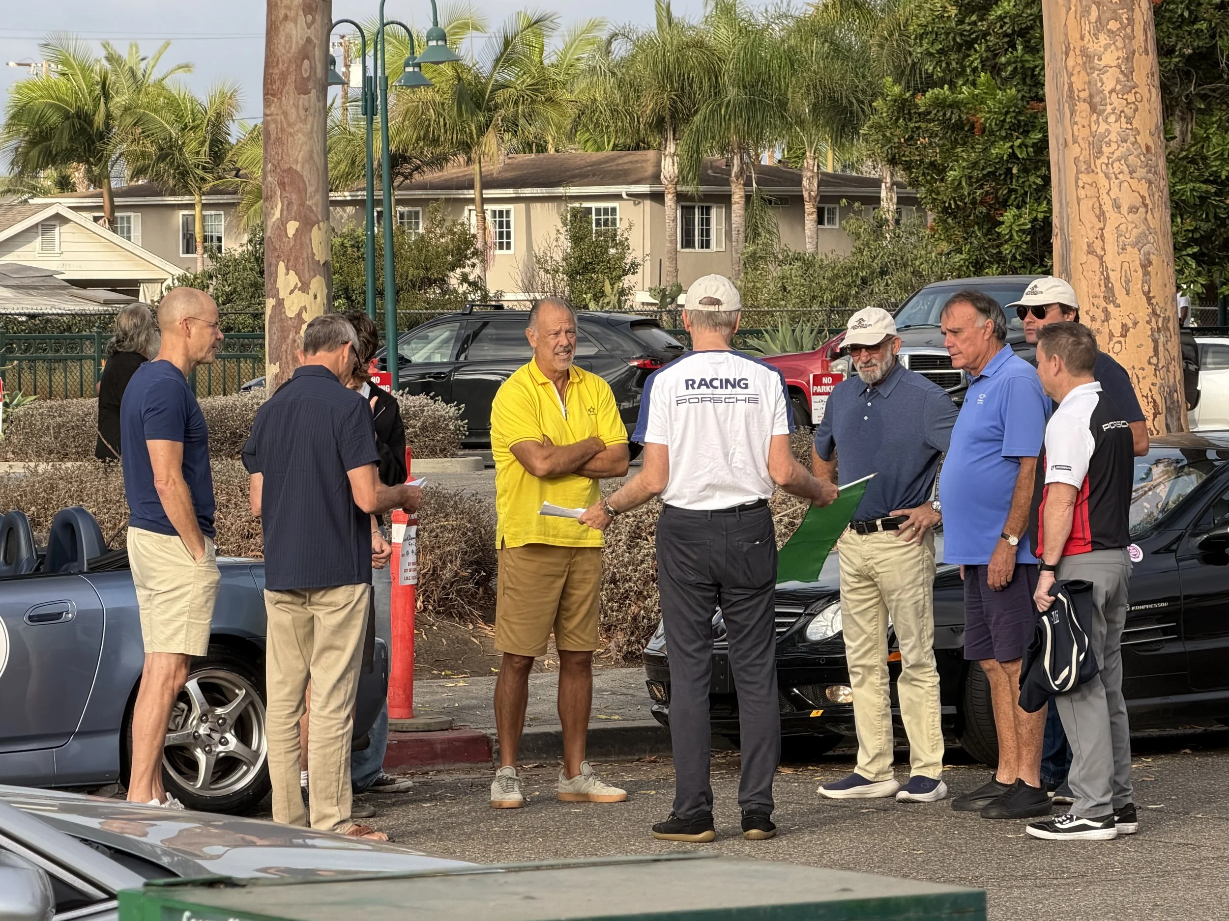 men-chatting-beside-convertibles-with-one-dressed-in-yellow--7b60bf64.jpeg