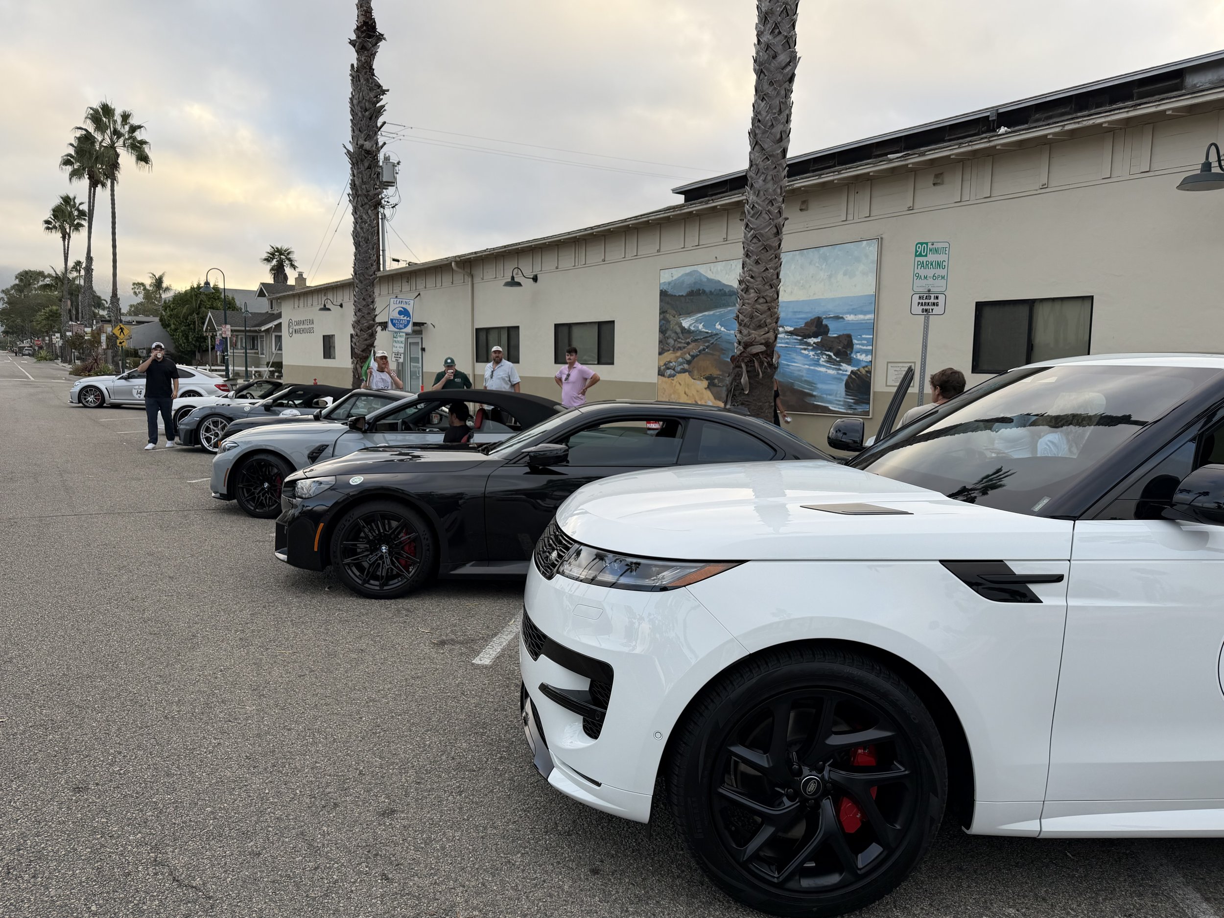white-range-rover-beside-a-row-of-sports-cars--ccc260d5.jpeg