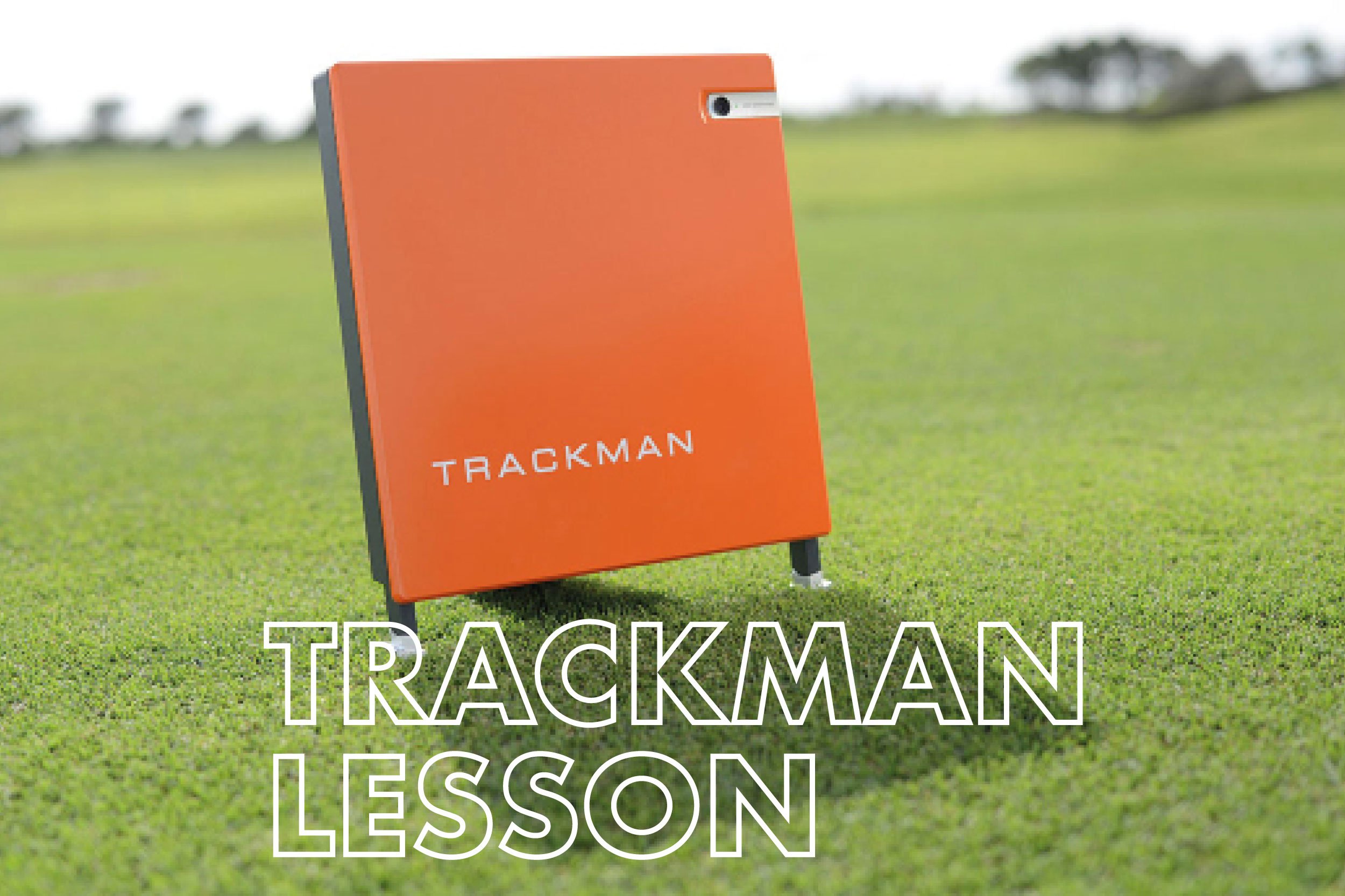 Orange sign with the word 'TRACKMAN' on a grassy field, with the text 'TRACKMAN LESSON' overlayed at the bottom.