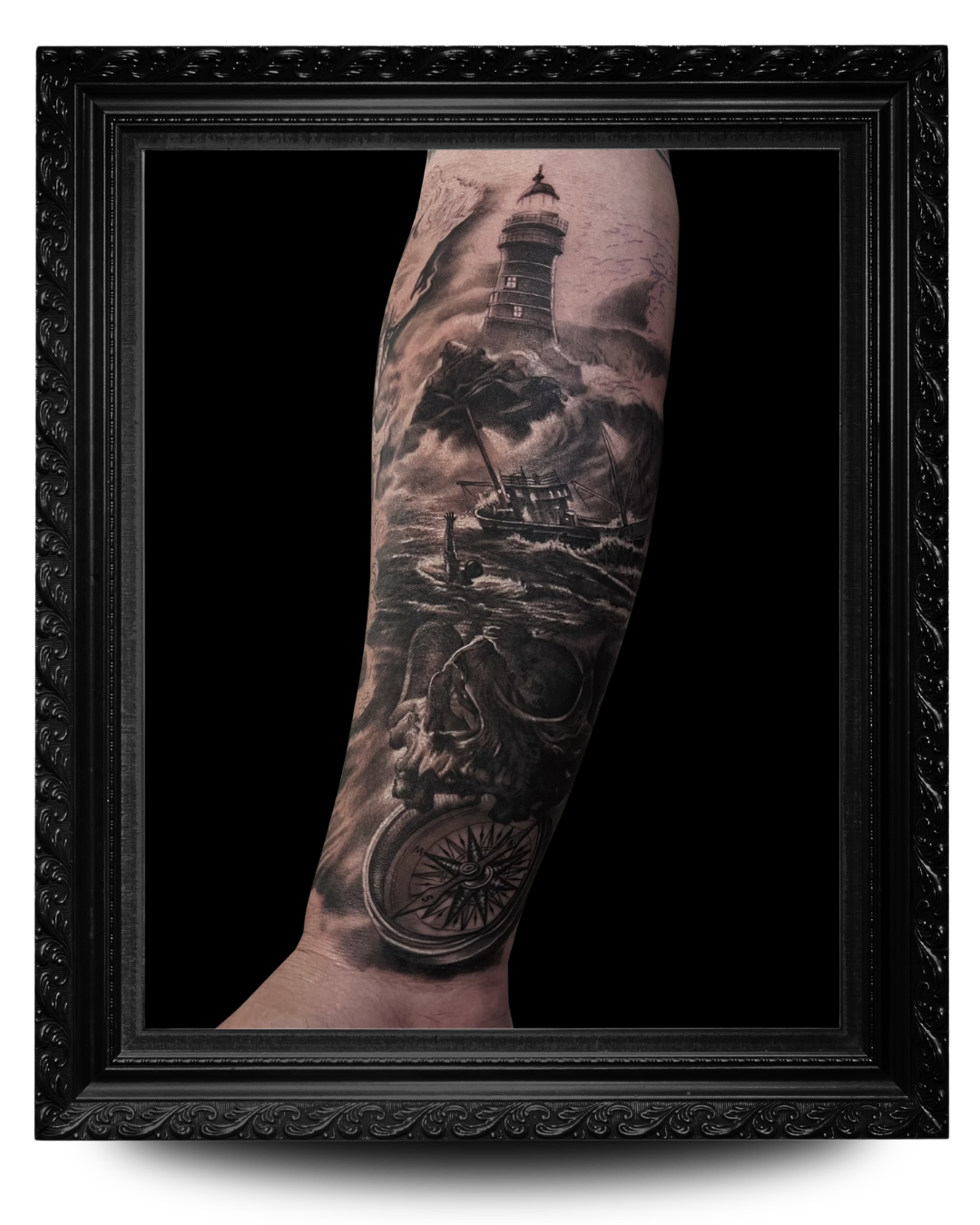 Black and grey tattoo of a lighthouse, a boat in rough seas, a skull with a snake, and a compass on a person's arm.