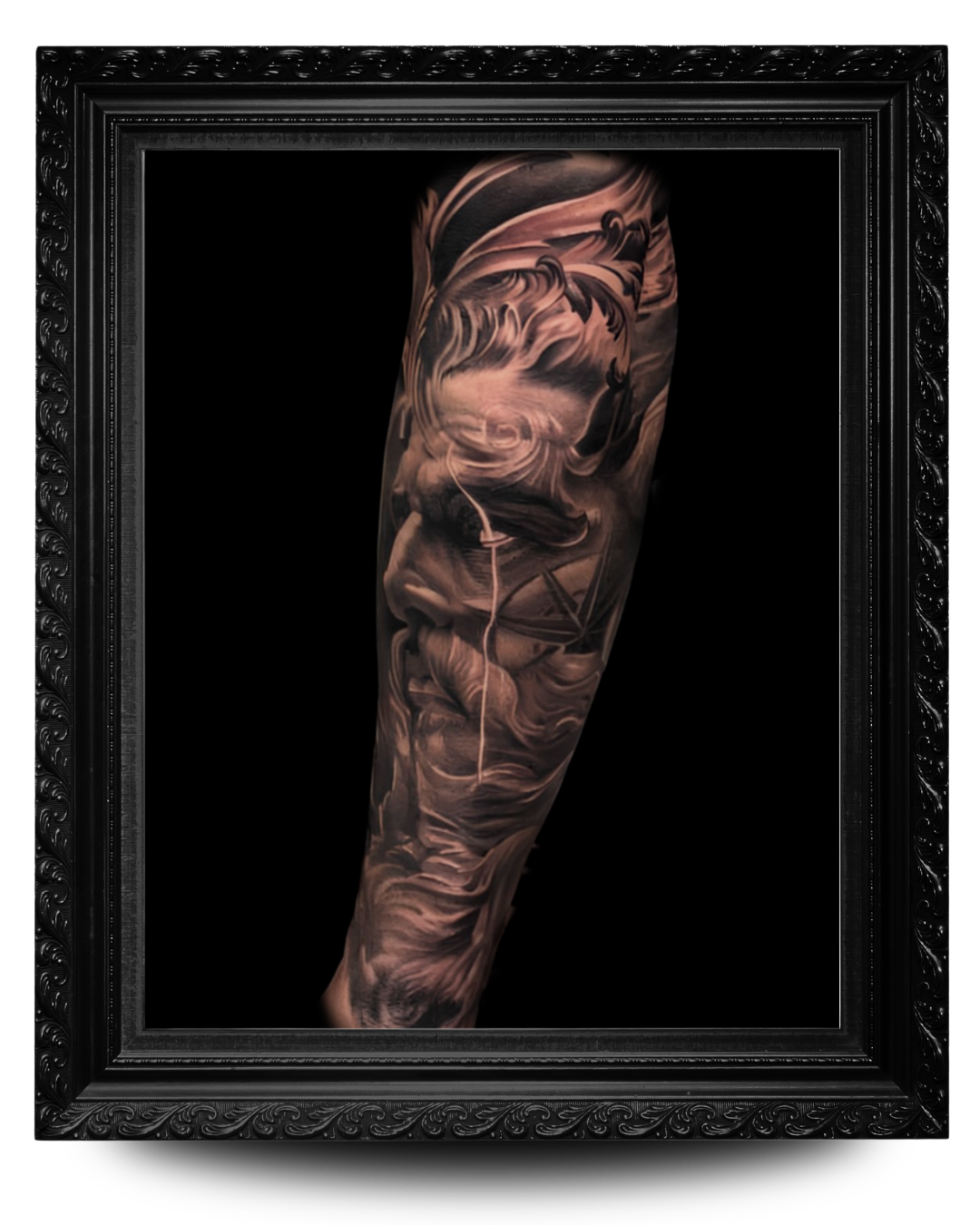 Close-up of a detailed black and gray tattoo sleeve on a person's arm, featuring swirling clouds, a ship's sail, and other nautical elements.