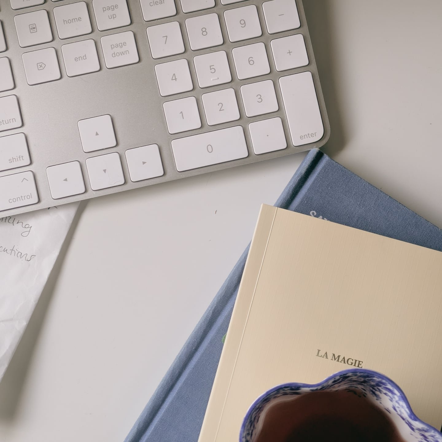 Messy desk. Scribbles on the back of a paper bag. 

I'm halfway through revisions of book one of my romantasy (title TBA). I started writing book one in 2024. I LOVE this world. With it being the third book I've finished writing, I can see the ways I