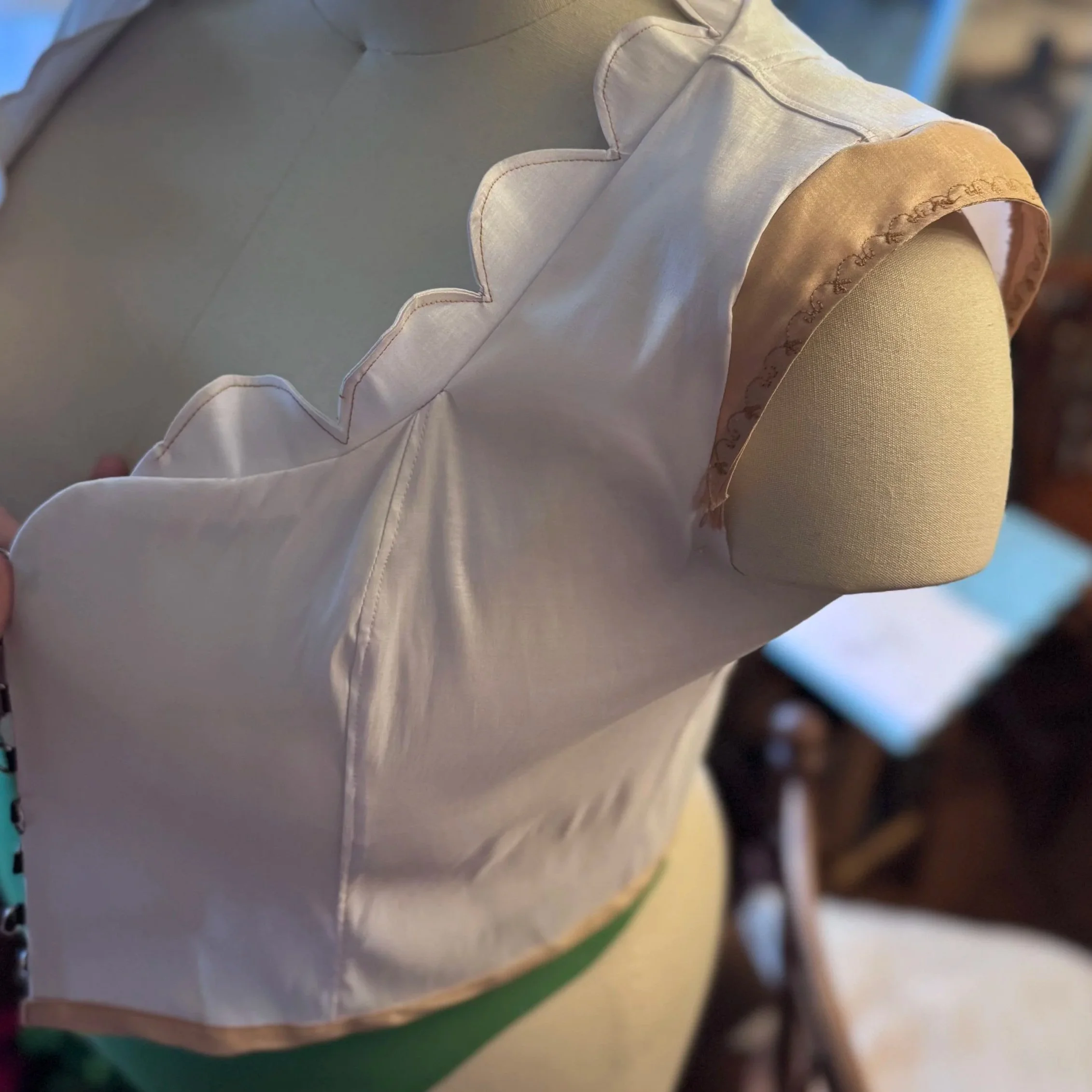 Detail view of scalloped standing collar and neckline.