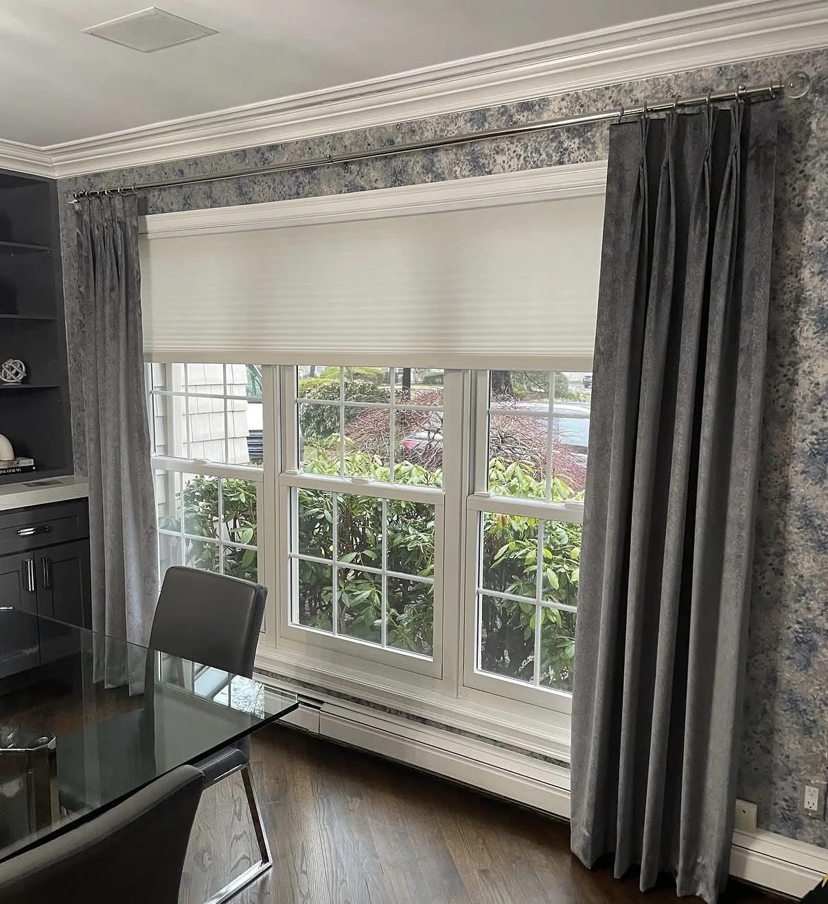 Hunter Douglas shades on a large window with custom draperies in a long island home.