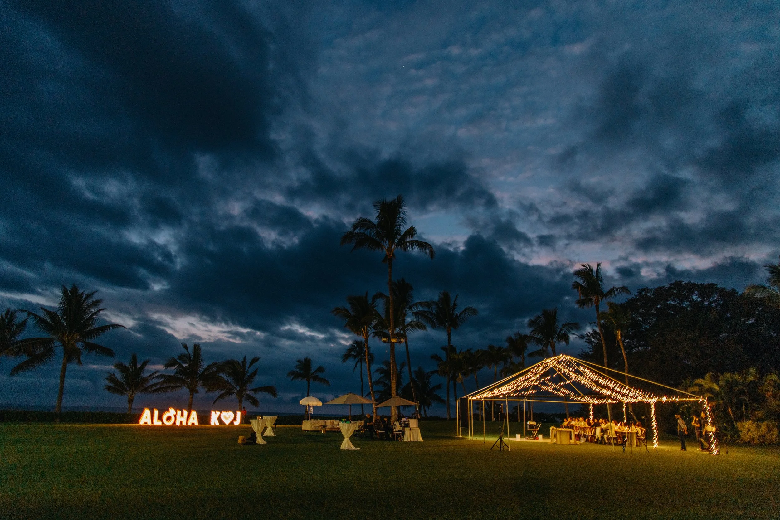 An outdoor evening celebration setup with a lit 