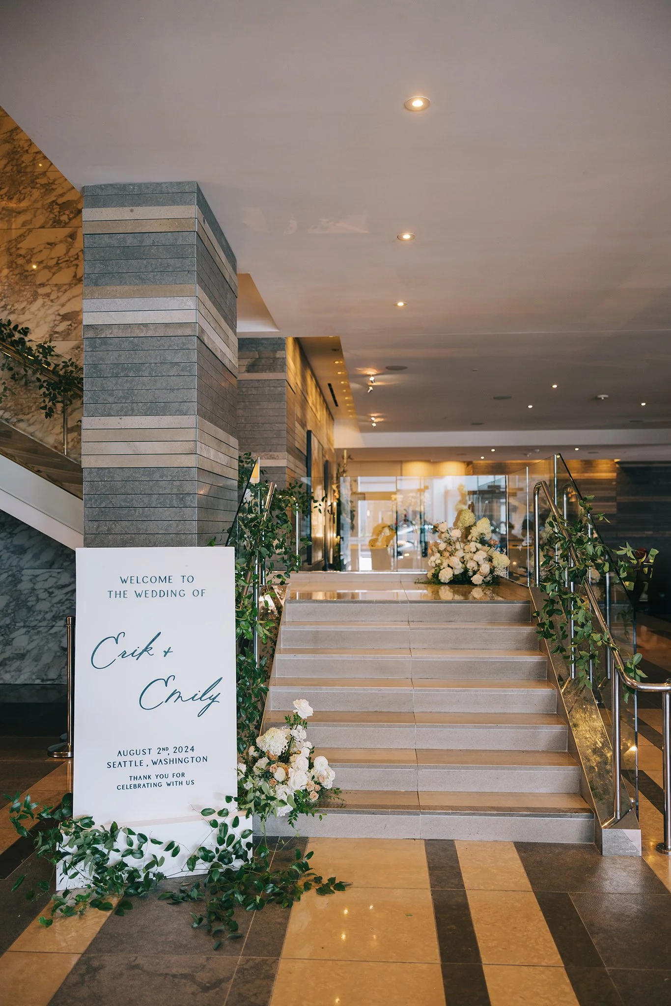 Wedding welcome sign with floral arrangements at hotel lobby entrance, Seattle, Washington, August 2nd, 2024.