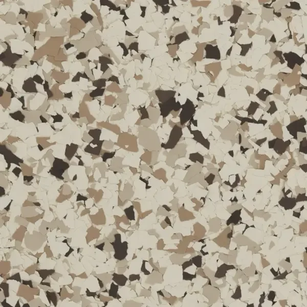 Close-up of a speckled beige, brown, black, and white epoxy floor flake