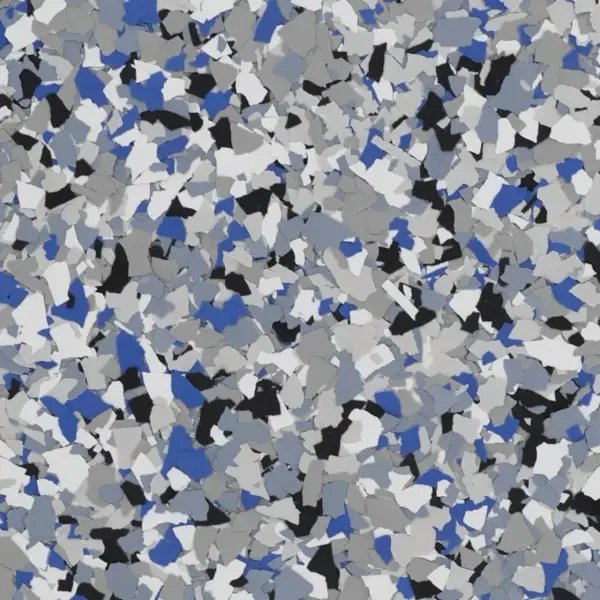 Close-up of multicolored epoxy floor flakes with shades of gray, black, white, and blue.
