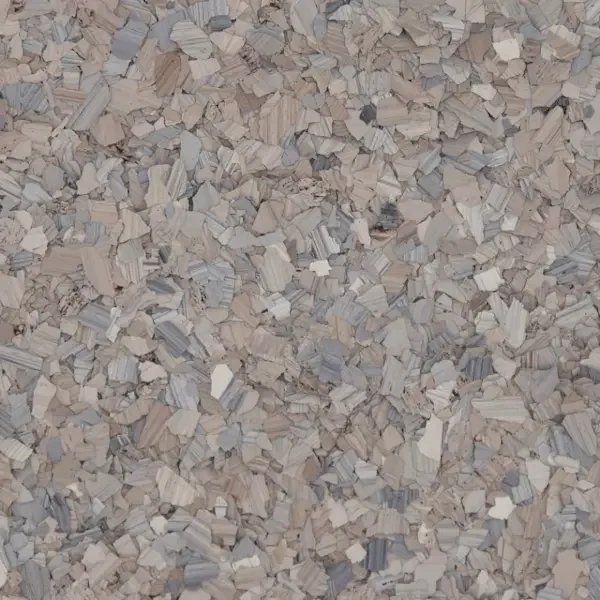 Close-up photo of a textured surface with tiny, irregularly shaped epoxy floor flakes of various shades of beige and gray.