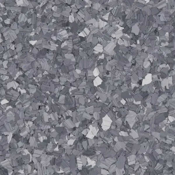 Close-up view of a surface covered with small, irregularly shaped epoxy floor flakes of grayish material.
