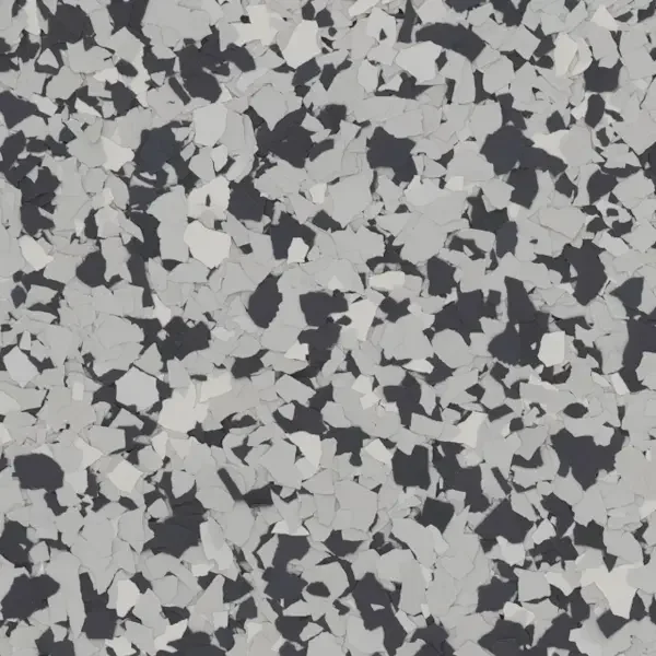 Close-up of black and white speckled epoxy flooring with irregular-shaped chips.