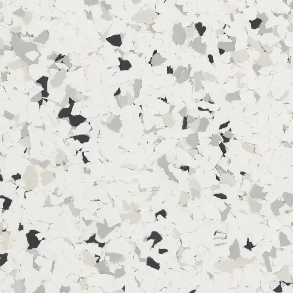 Close-up of white, black, and gray terrazzo floor with scattered epoxy floor flakes
