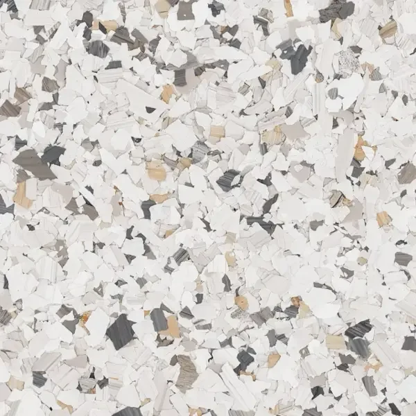 Close-up of multicolored shredded epoxy floor flakes in white, black, beige, and gray colors.
