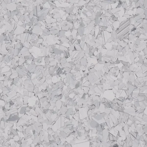 Small white epoxy floor flakes flakes scattered over a surface.