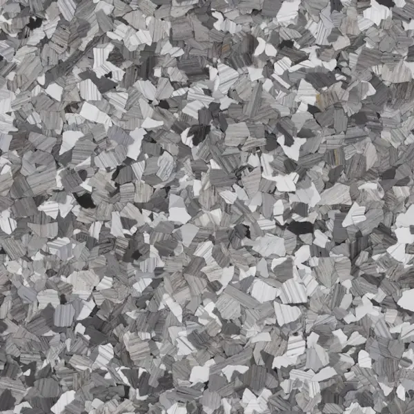 Close-up of shredded gray, white, and black epoxy floor flakes