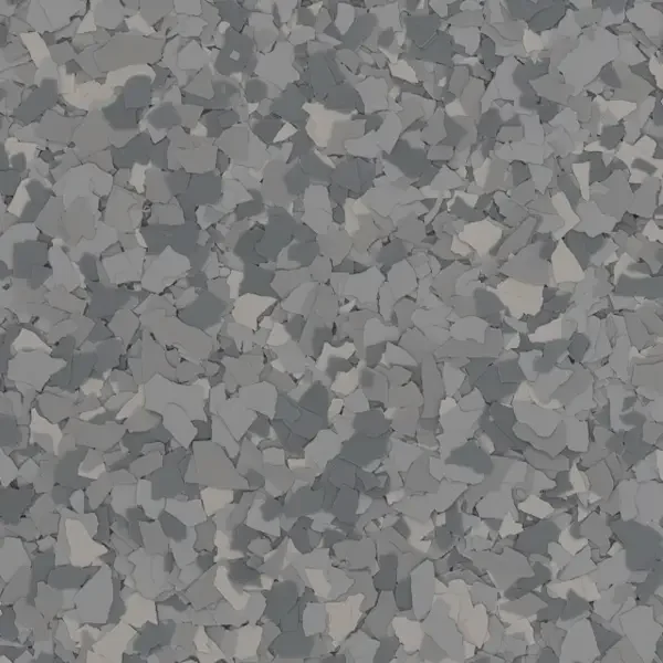 Close-up of a surface covered with small, irregularly shaped gray and white epoxy floor flakes