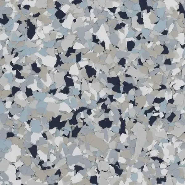 Close-up view of multicolored epoxy floor flakes in shades of black, white, silver, and gray.