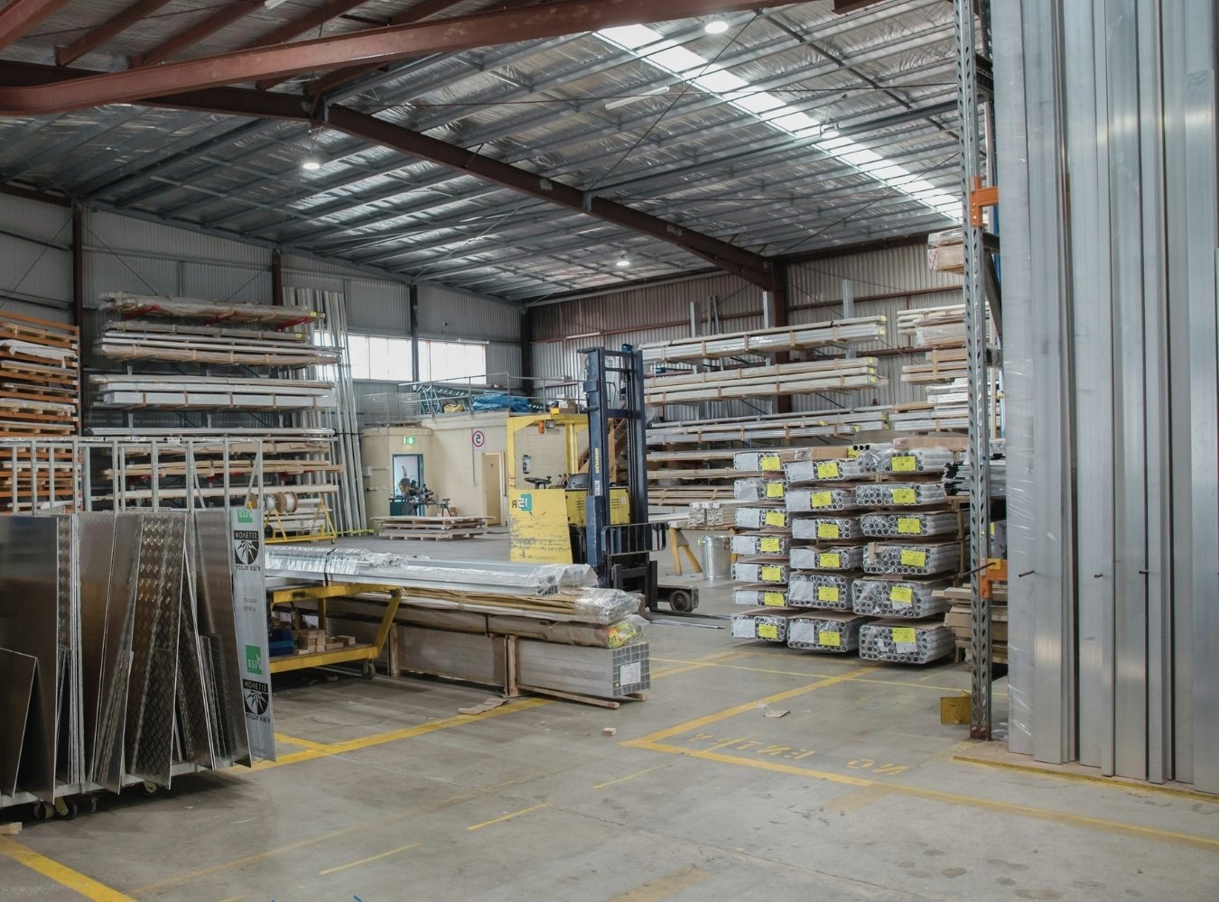 Commercial electrician installing lighting in a business space