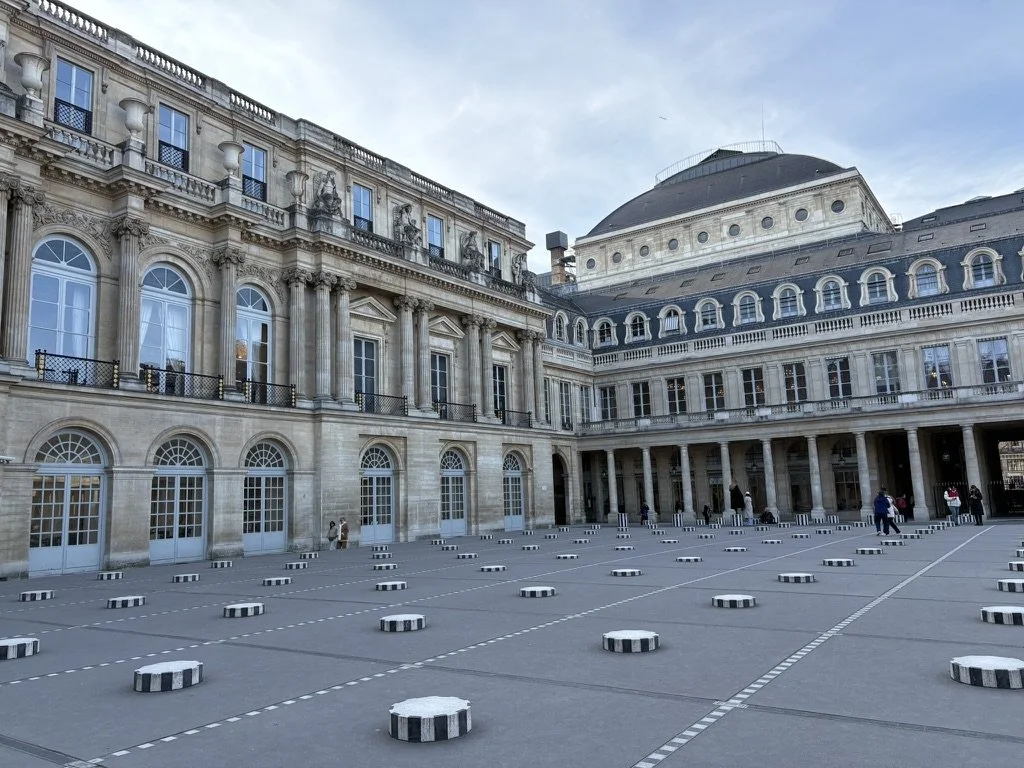 Photo showing the black and white striped columns of the Palais Royale in Paris.