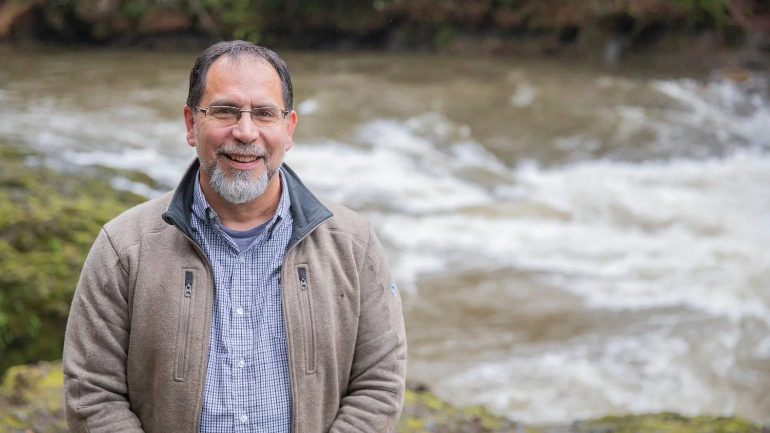 Former Chehalis Tribe Chairman David Burnett smiles for a photo in front of the Chehalis River at Rainbow Falls State Park near Dryad. This location is a traditional hunting ground for lamprey by the Chehalis Tribe.