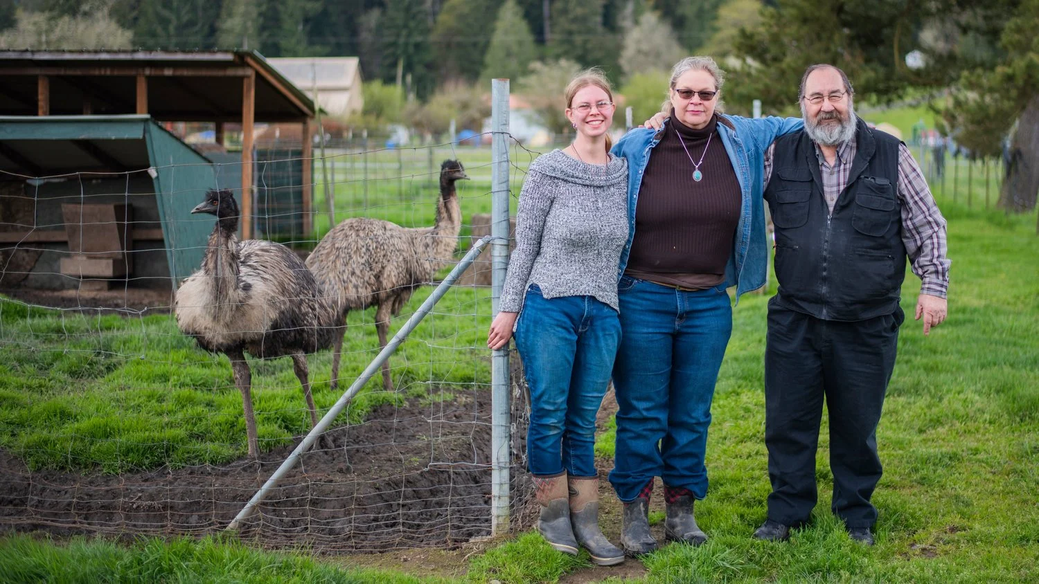 From left, Emily Polkinghorne, her mother Janean Parker and step-father Tony Citrhyn pose for a photo with their emus Kate and Kronos Friday at 3 Feathers Emu Ranch and Farm in Adna.