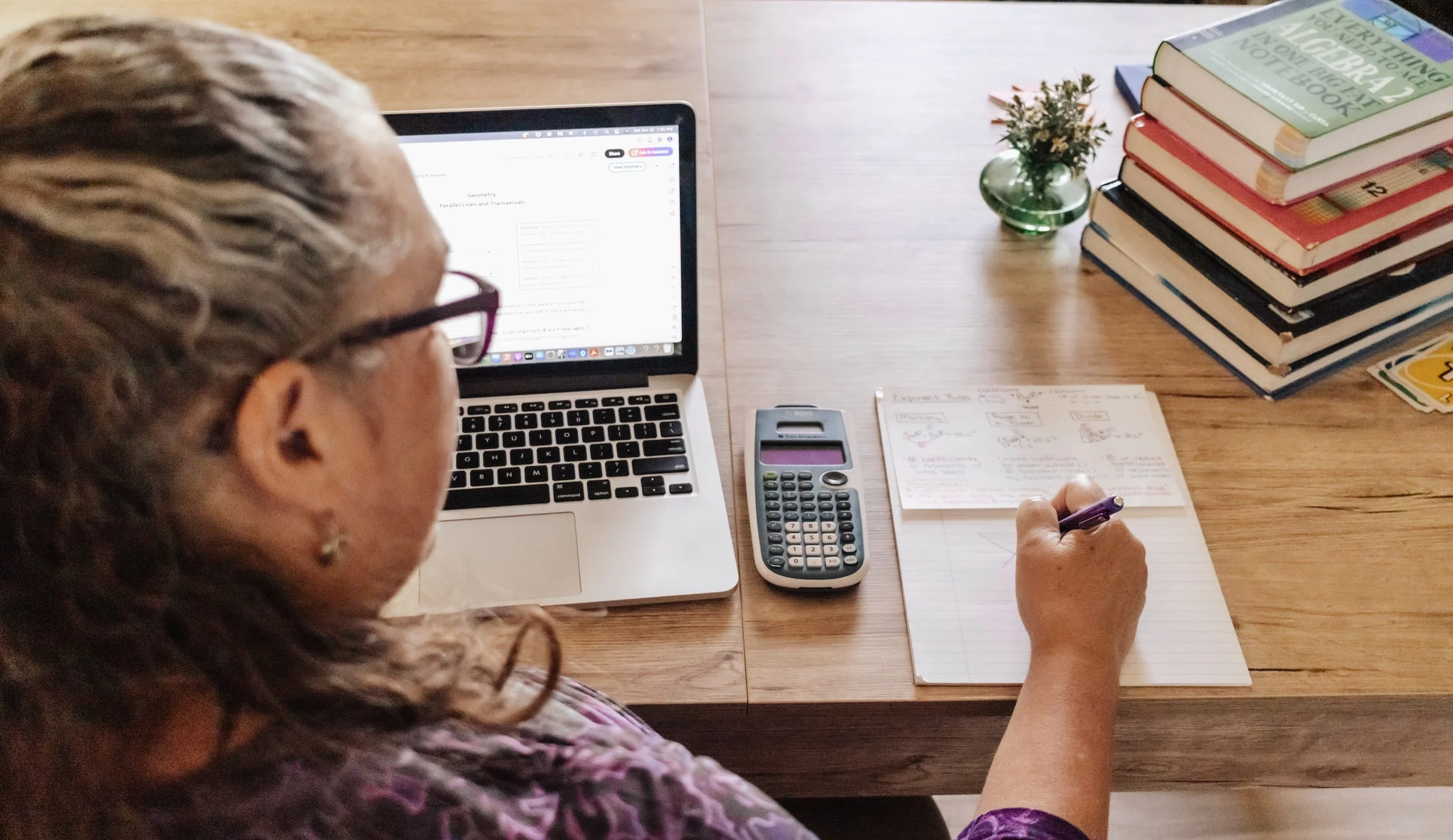 Math tutor reviewing student notes and problems at her desk — individualized tutoring in Montgomery County, PA