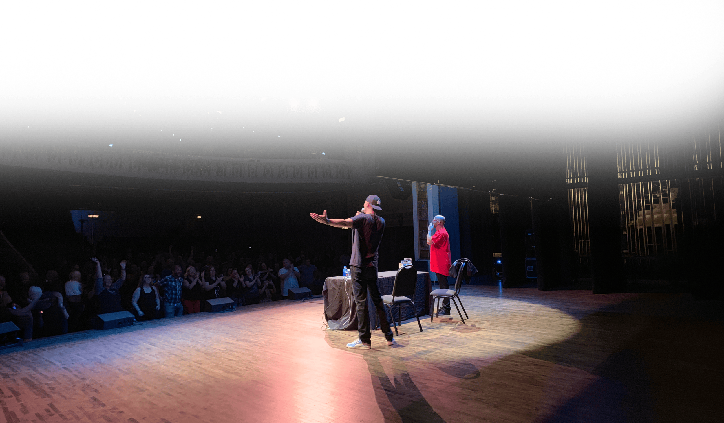 James and Jimmie on a stage facing the crowd at a Live Show