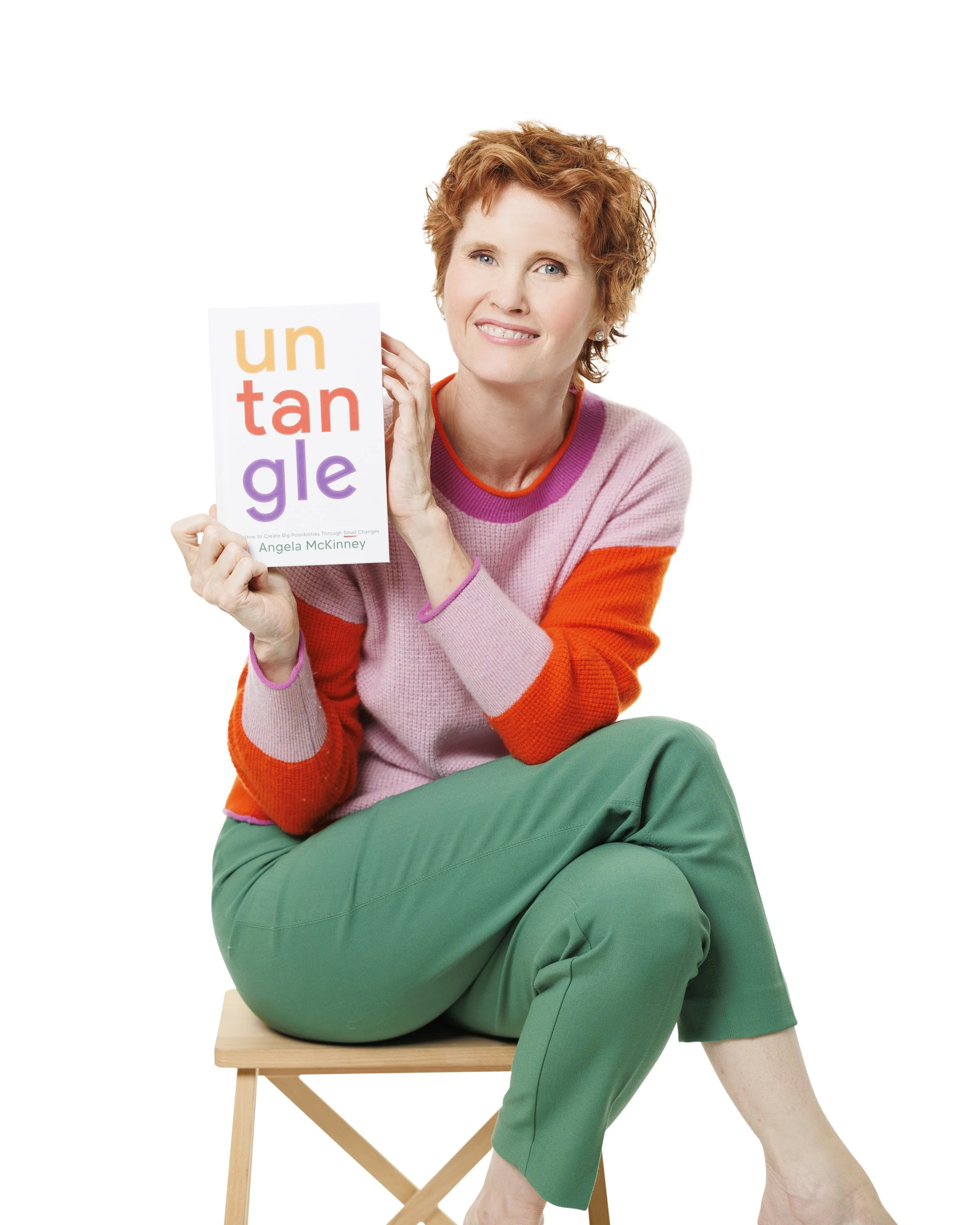 Headshot of Angela McKinney holding book Untangle