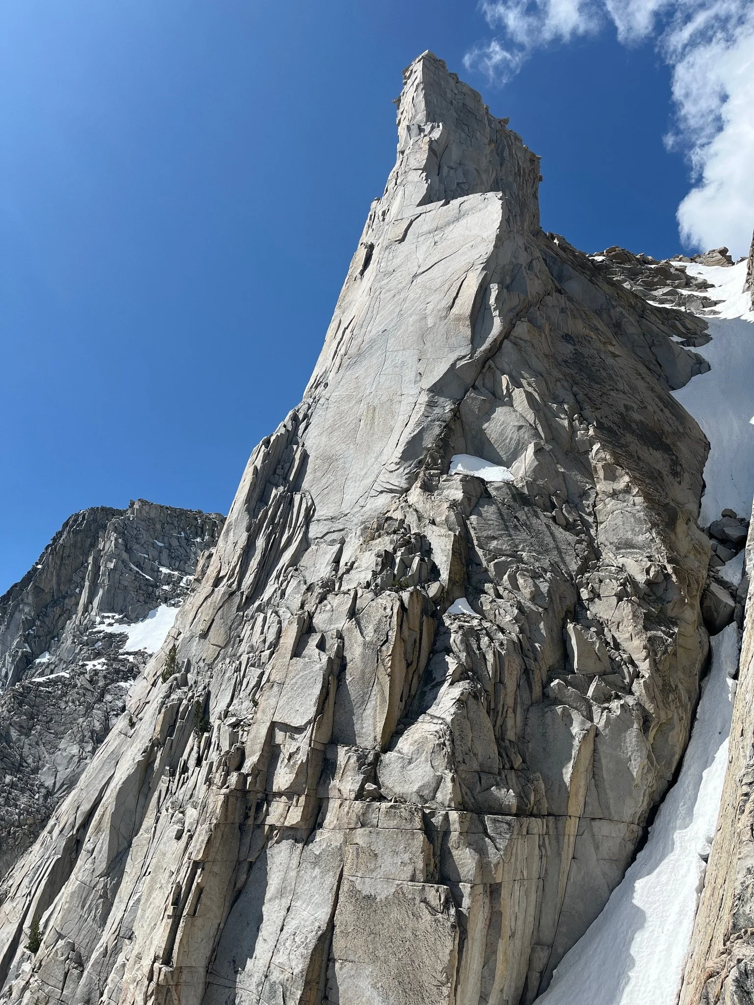 A massive pillar of granite against a clear blue sky