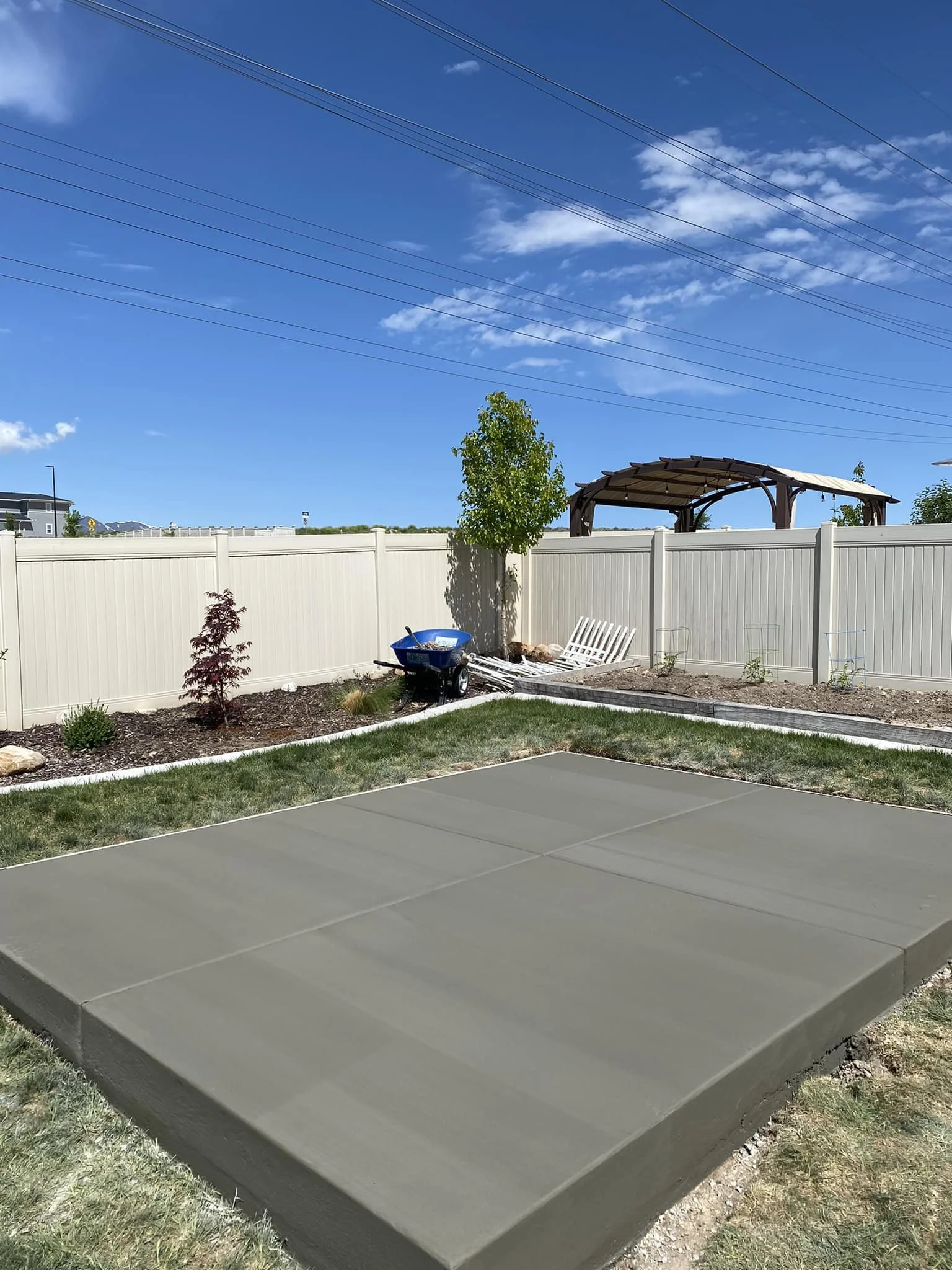 Backyard with a paved concrete area.