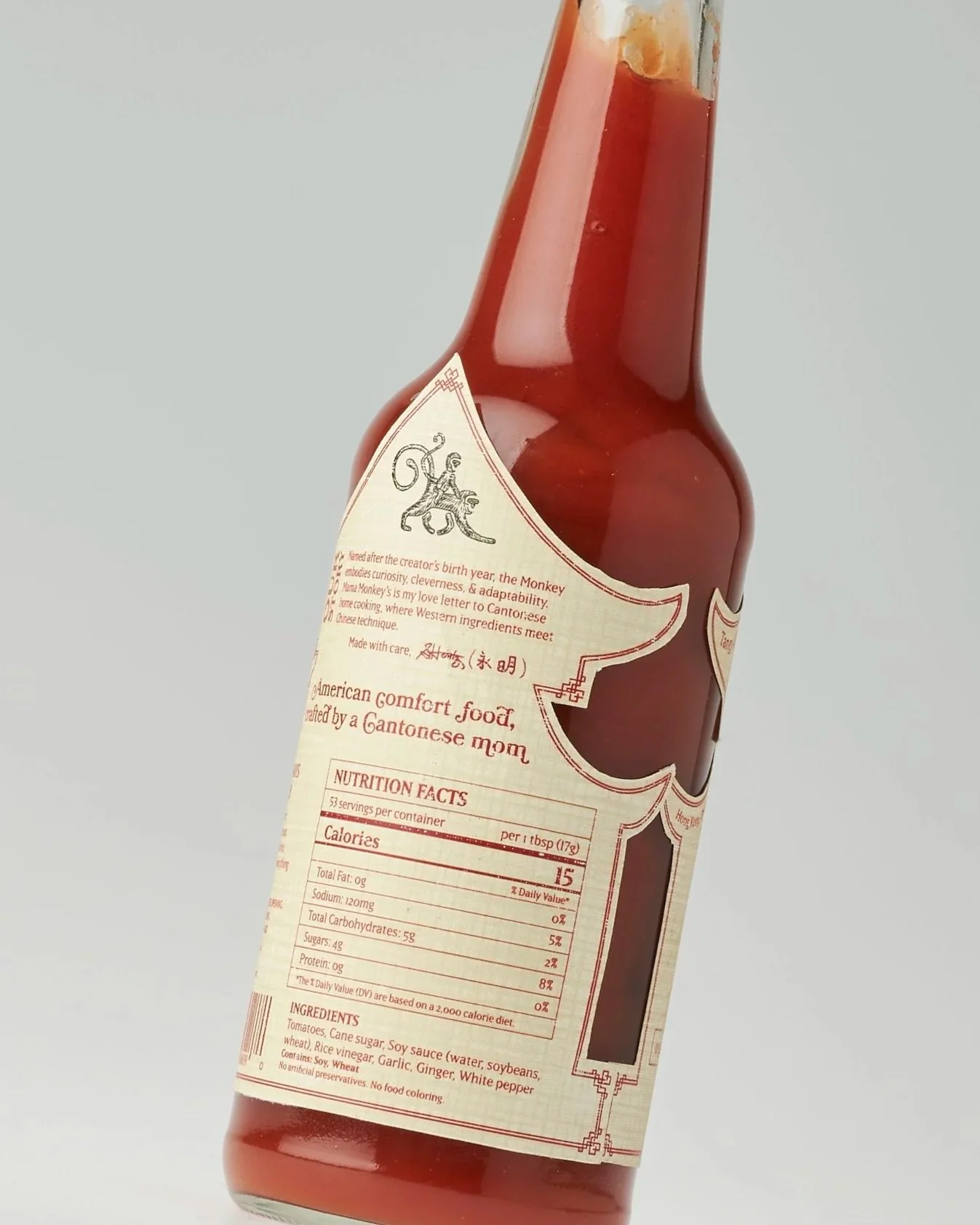 A bottle of Asian sauce with a red label featuring text about Cantonese cuisine, nutrition facts, and ingredients.