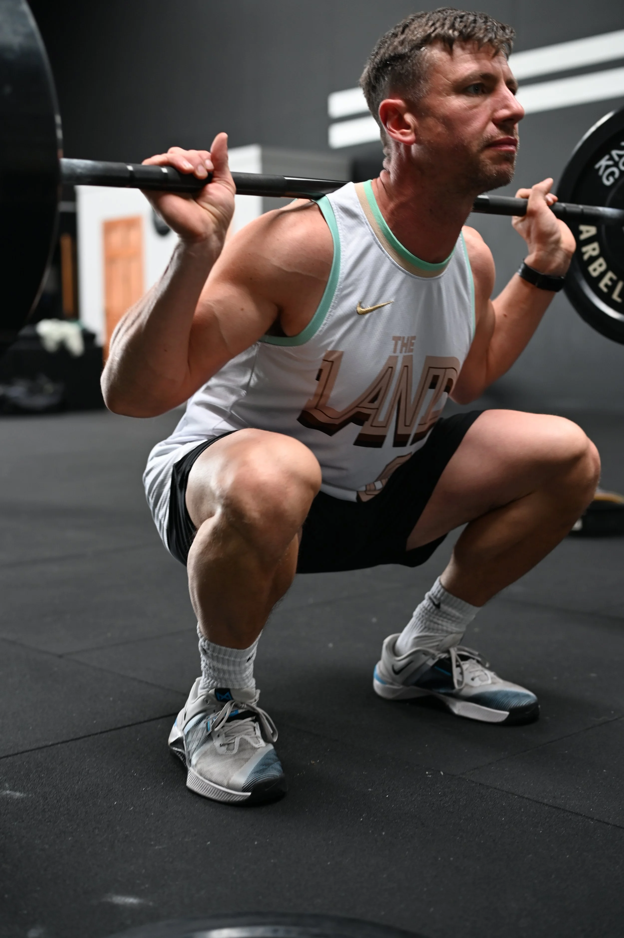 Athlete performing a back squat at Alliance Training Club