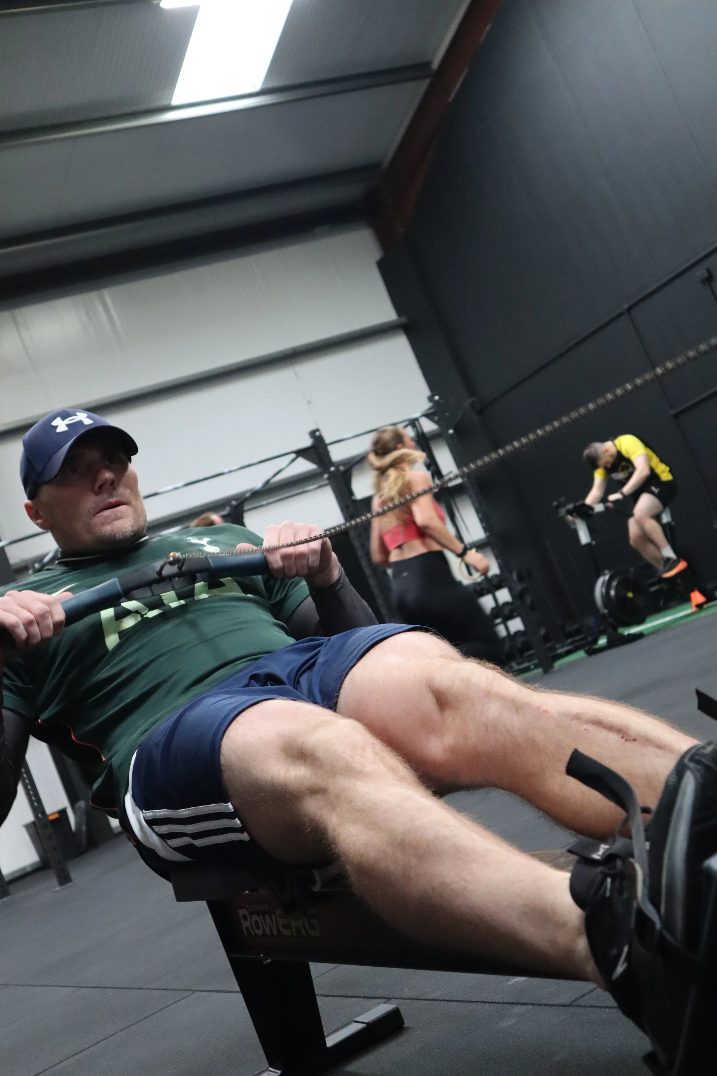 HYROX class athlete mid-workout on the Row ERG at Alliance Training Club