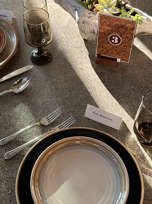 A modern, edgy wedding tablescape with mixed and matched collections from Stoned dishes, Mixtalics silverware, and Accent water and wine glasses (Libbey) for rent.