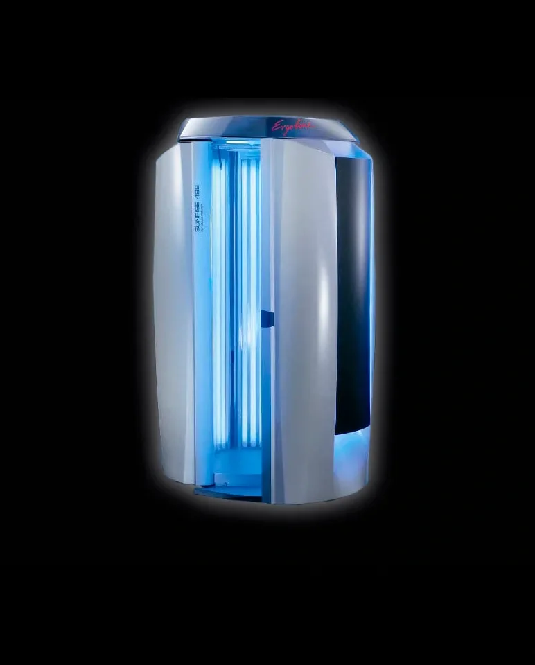 A white and black vertical tanning bed with bright blue UV light strips in the center, against a black background.