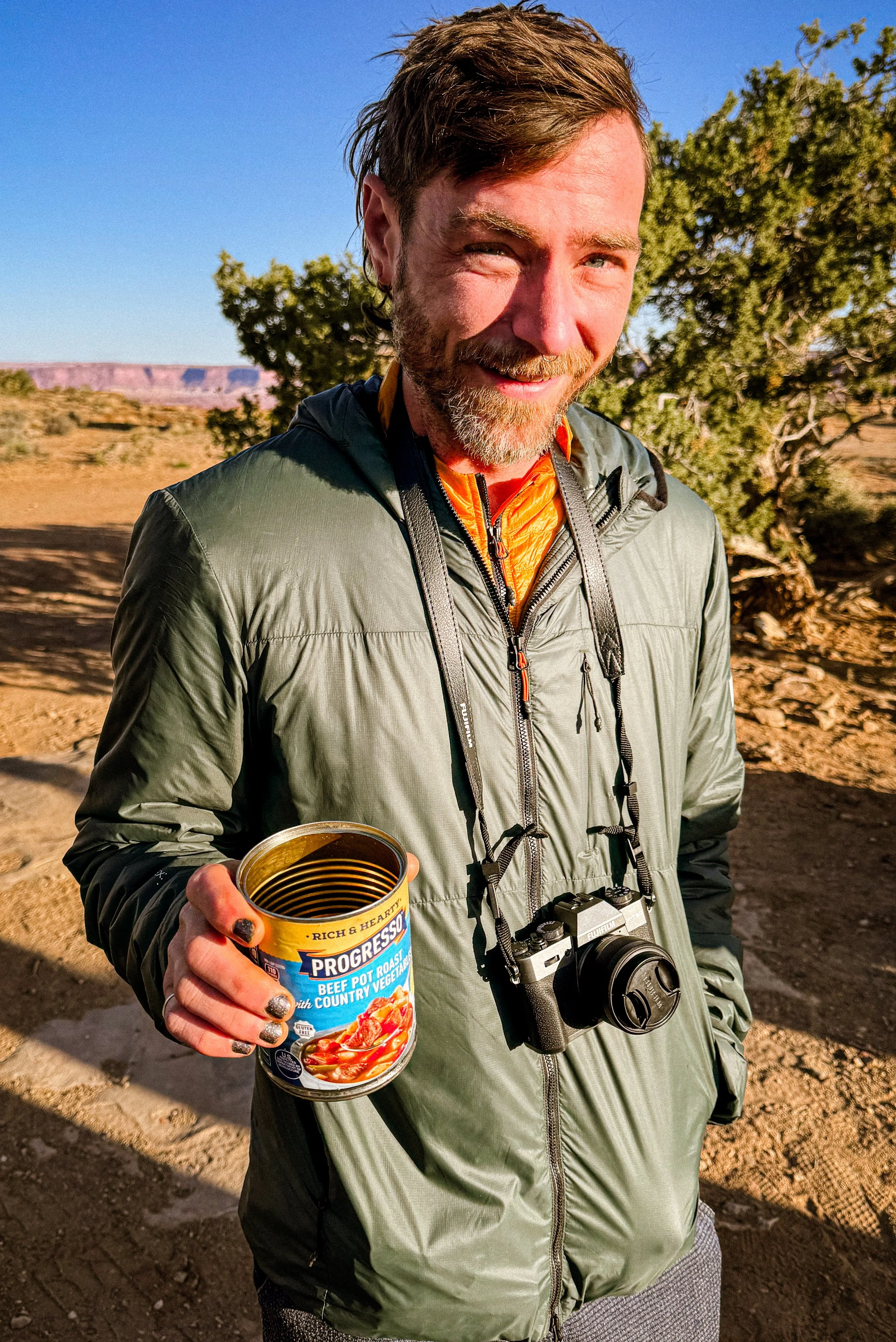 man drinking camp coffee from a soup can