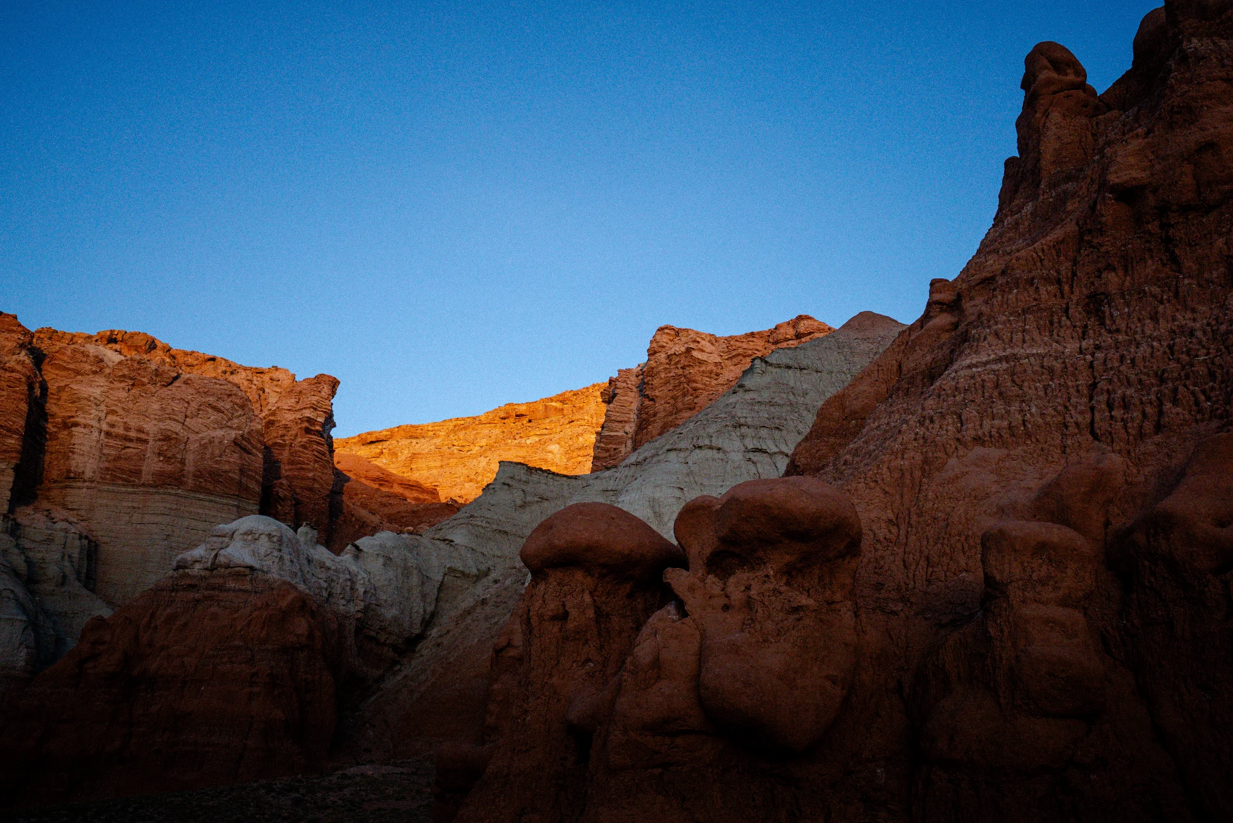 Sunset light hitting the top of a desert ridge