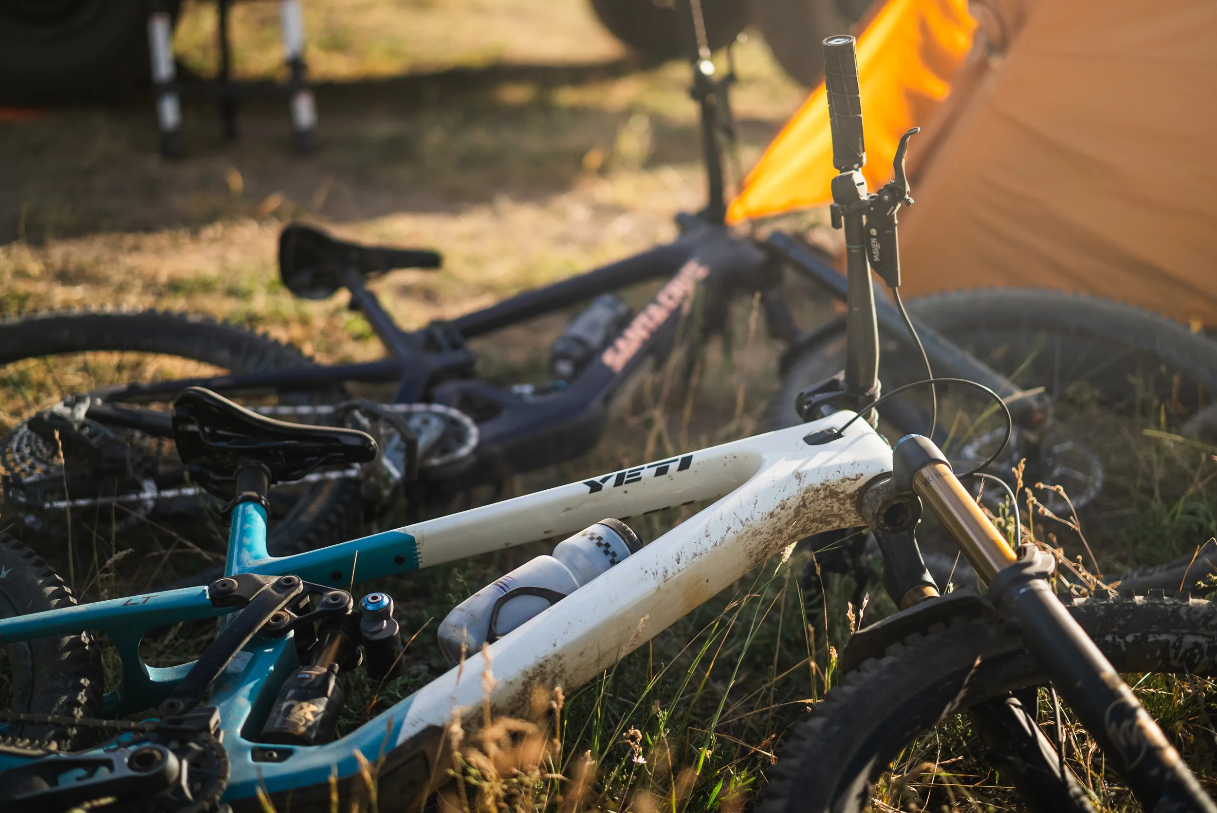 mountain bikes in front of a tent on the ground