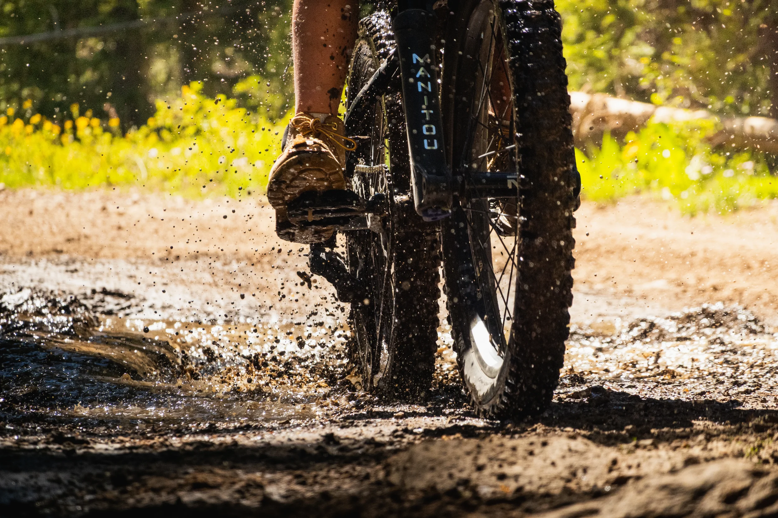 child on a bike in the mud