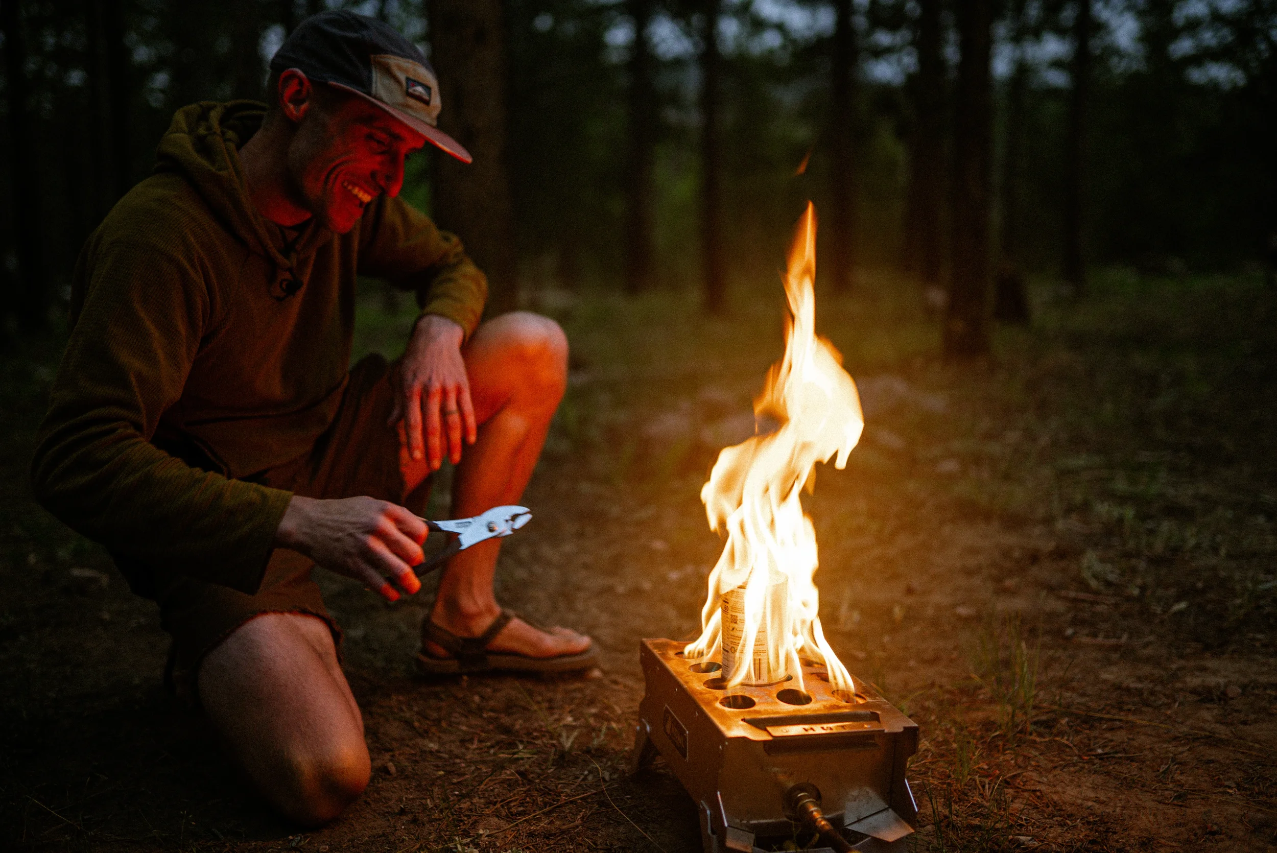 man moving a can of peaches in a fire with pliers