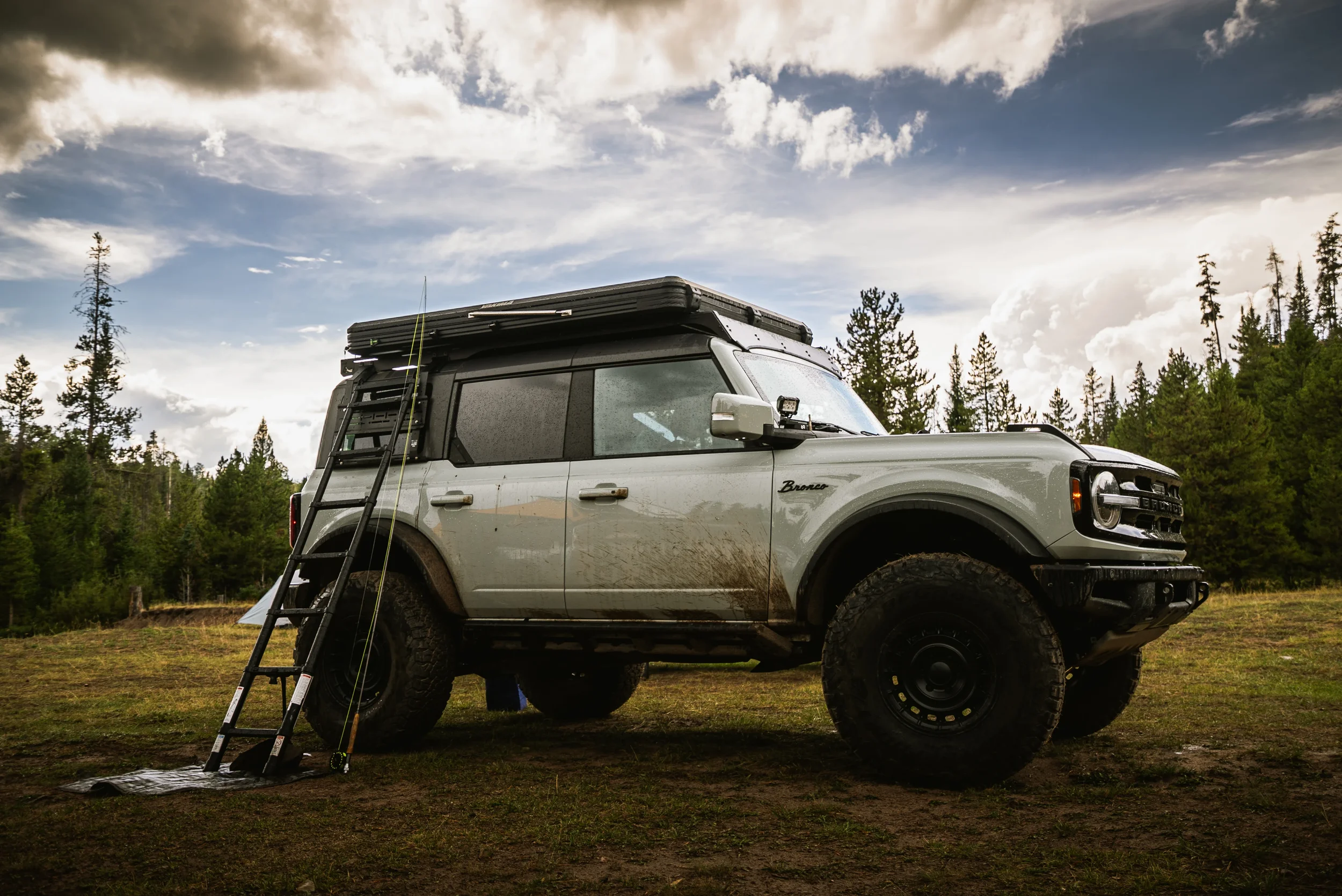 ford bronco with a fly rod leaning against it