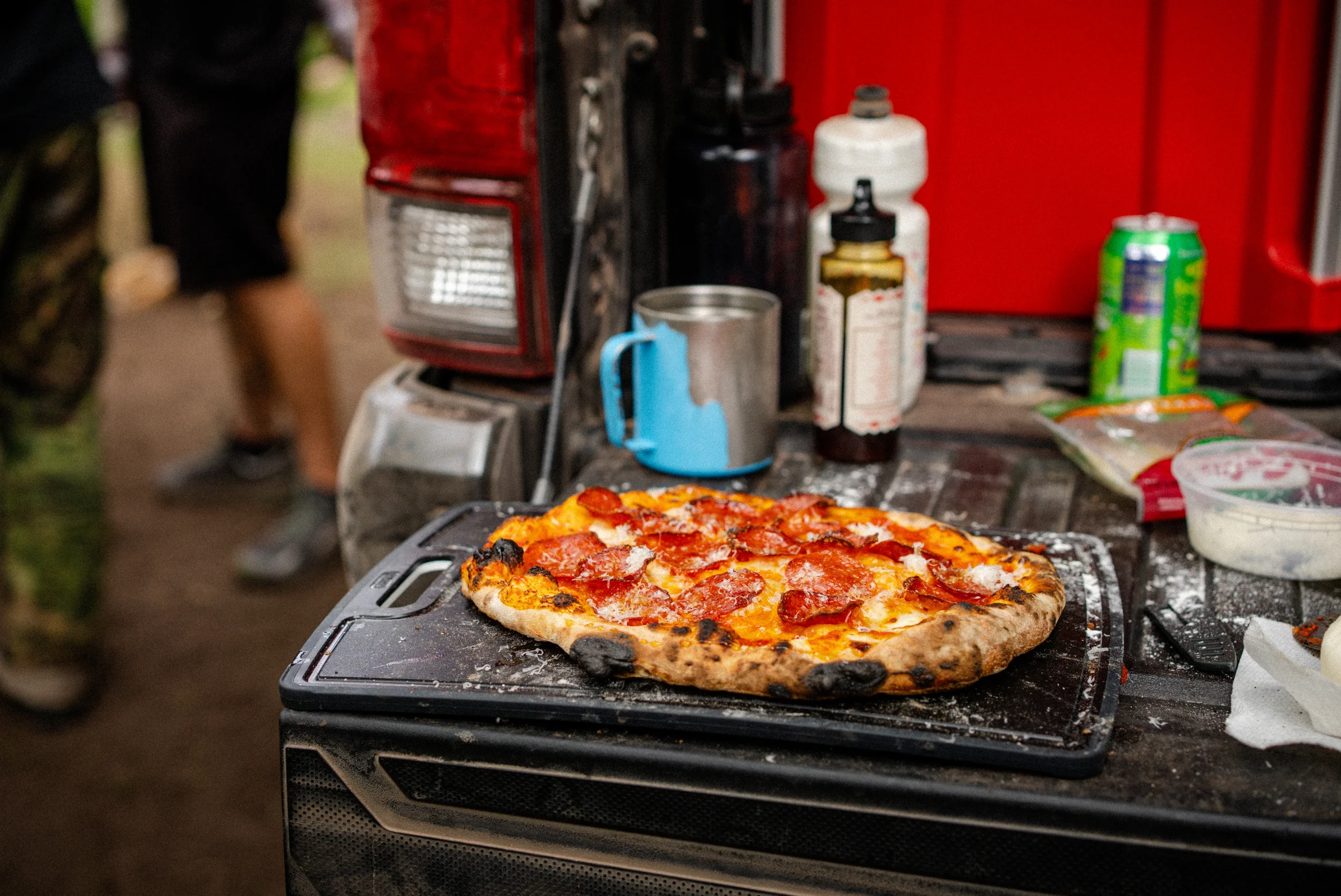 pepperoni pizza on a truck tailgate